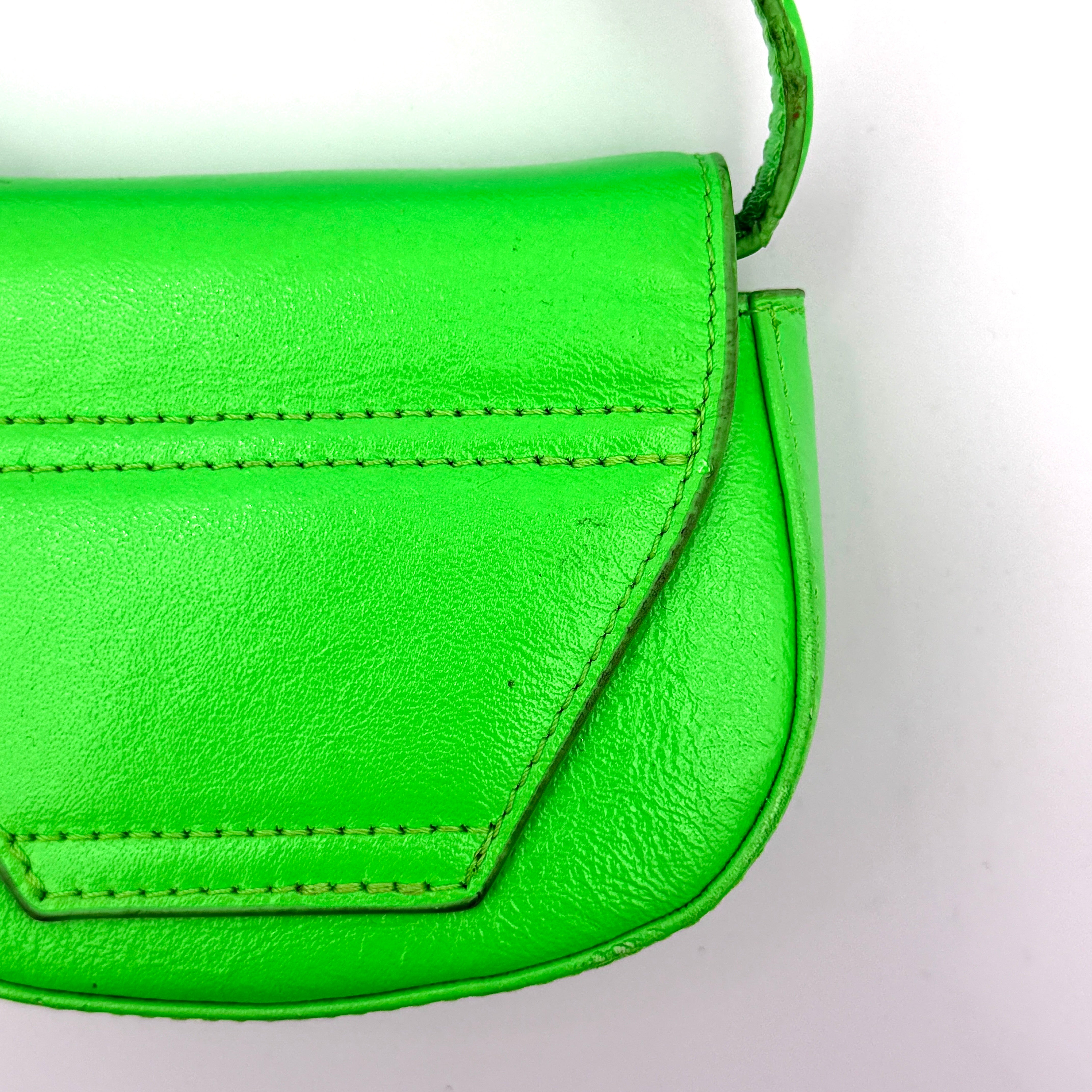 Diesel 1DR-XS Mini Bag in vivid neon green leather with bold silver D plaque and detachable strap, presented against a clean background.