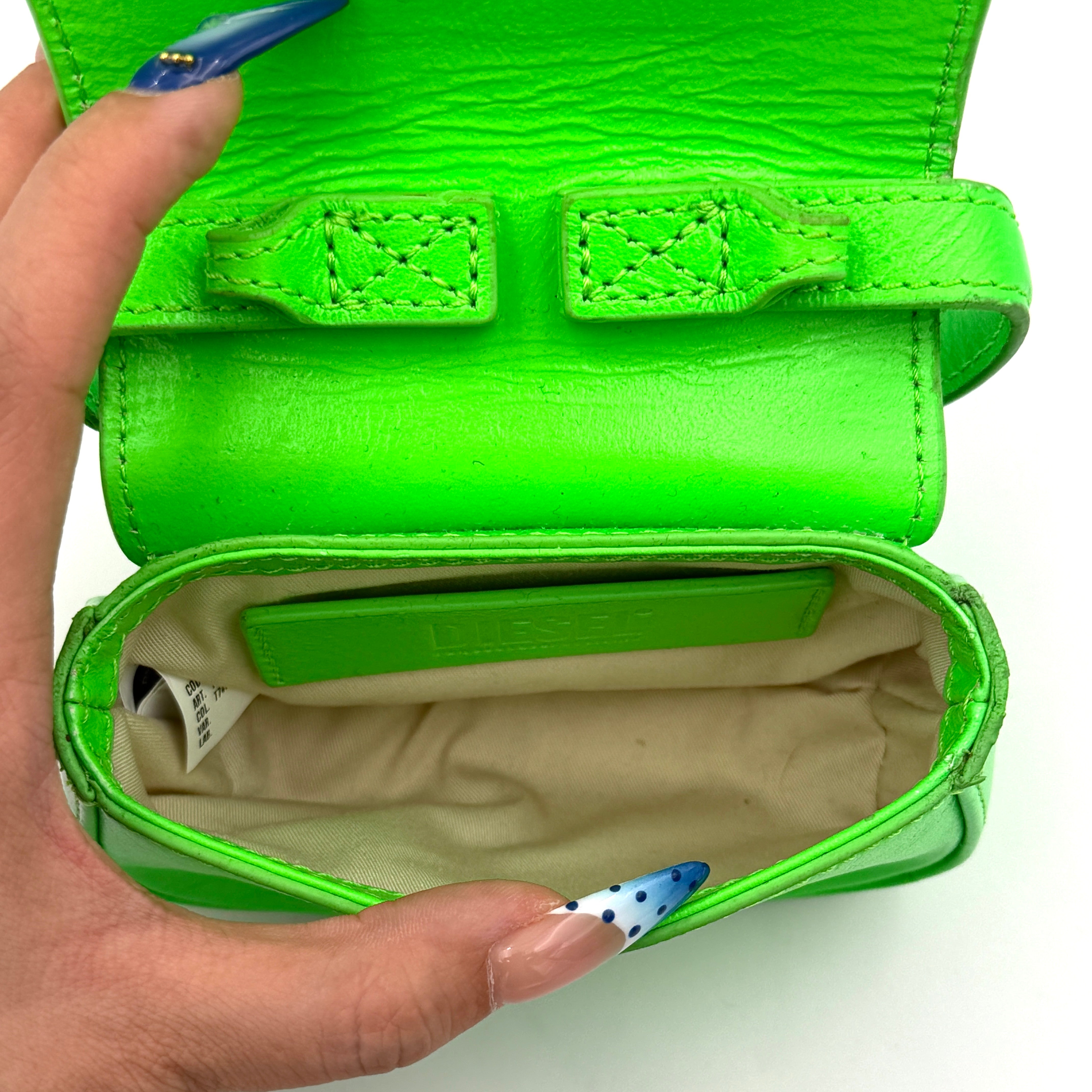 Diesel 1DR-XS Mini Bag in vivid neon green leather with bold silver D plaque and detachable strap, presented against a clean background.