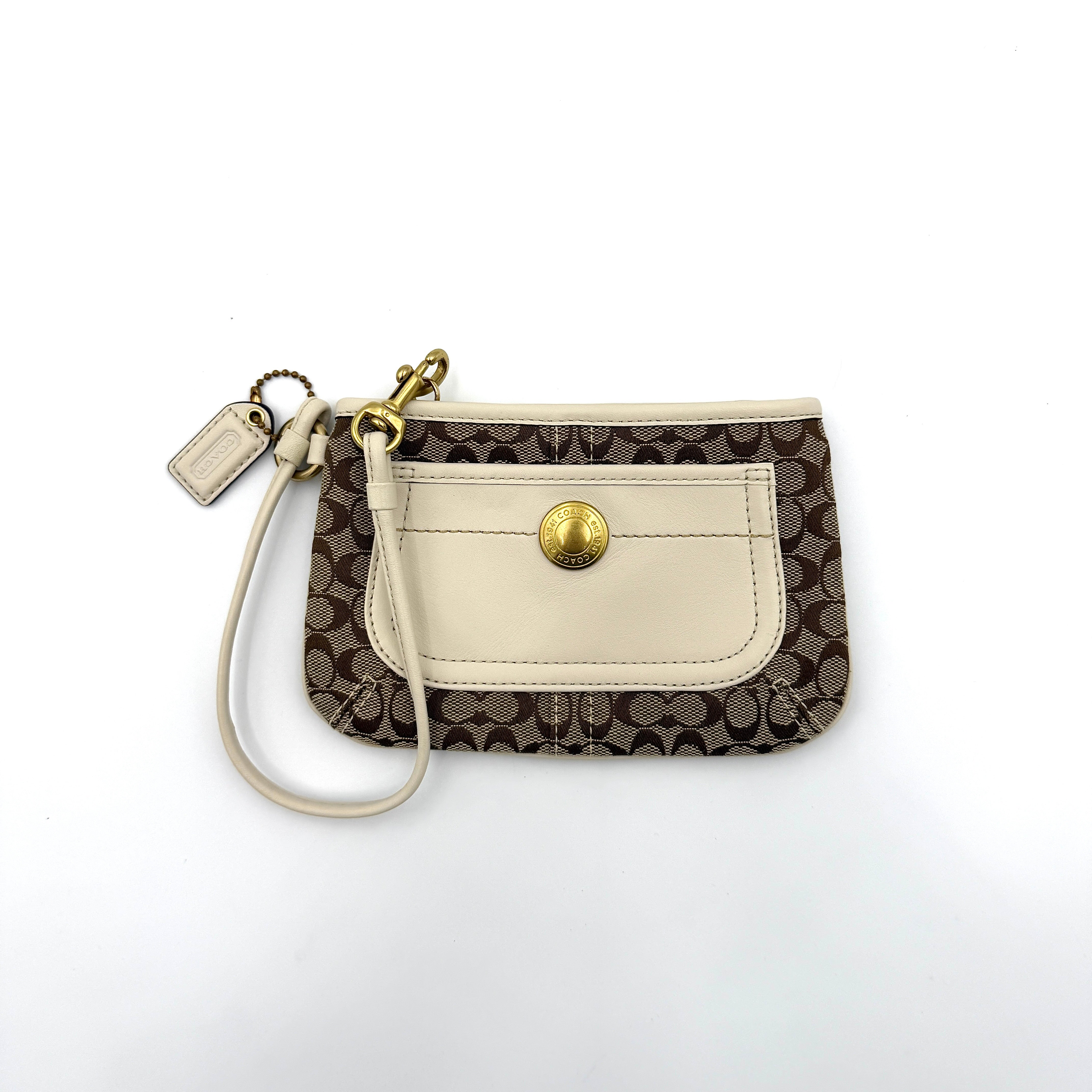 Coach Signature Canvas Wristlet in brown and ivory leather with gold-tone hardware and detachable wrist strap.