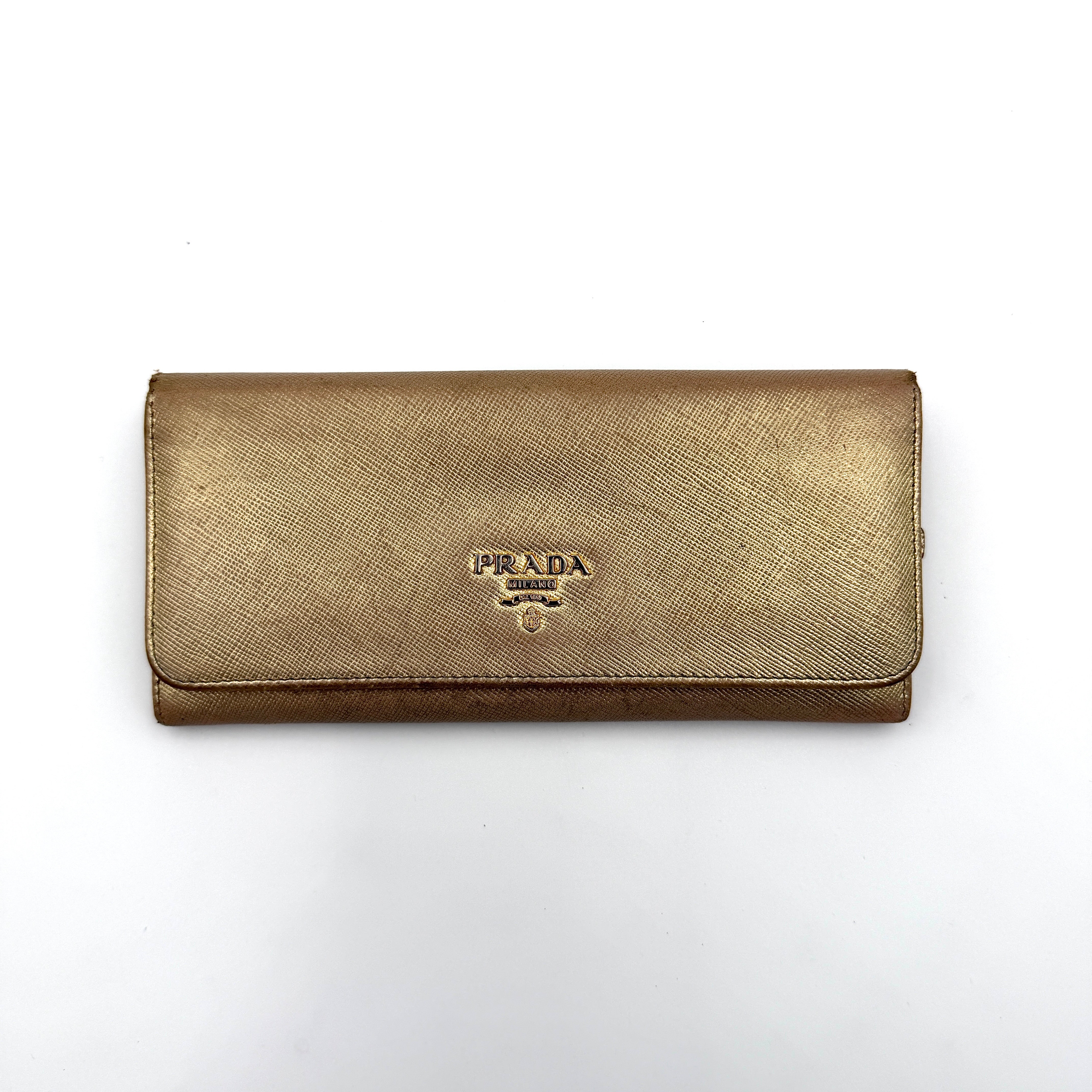 Prada Saffiano Continental Long Wallet in metallic gold Saffiano leather with gold-tone logo and structured silhouette.