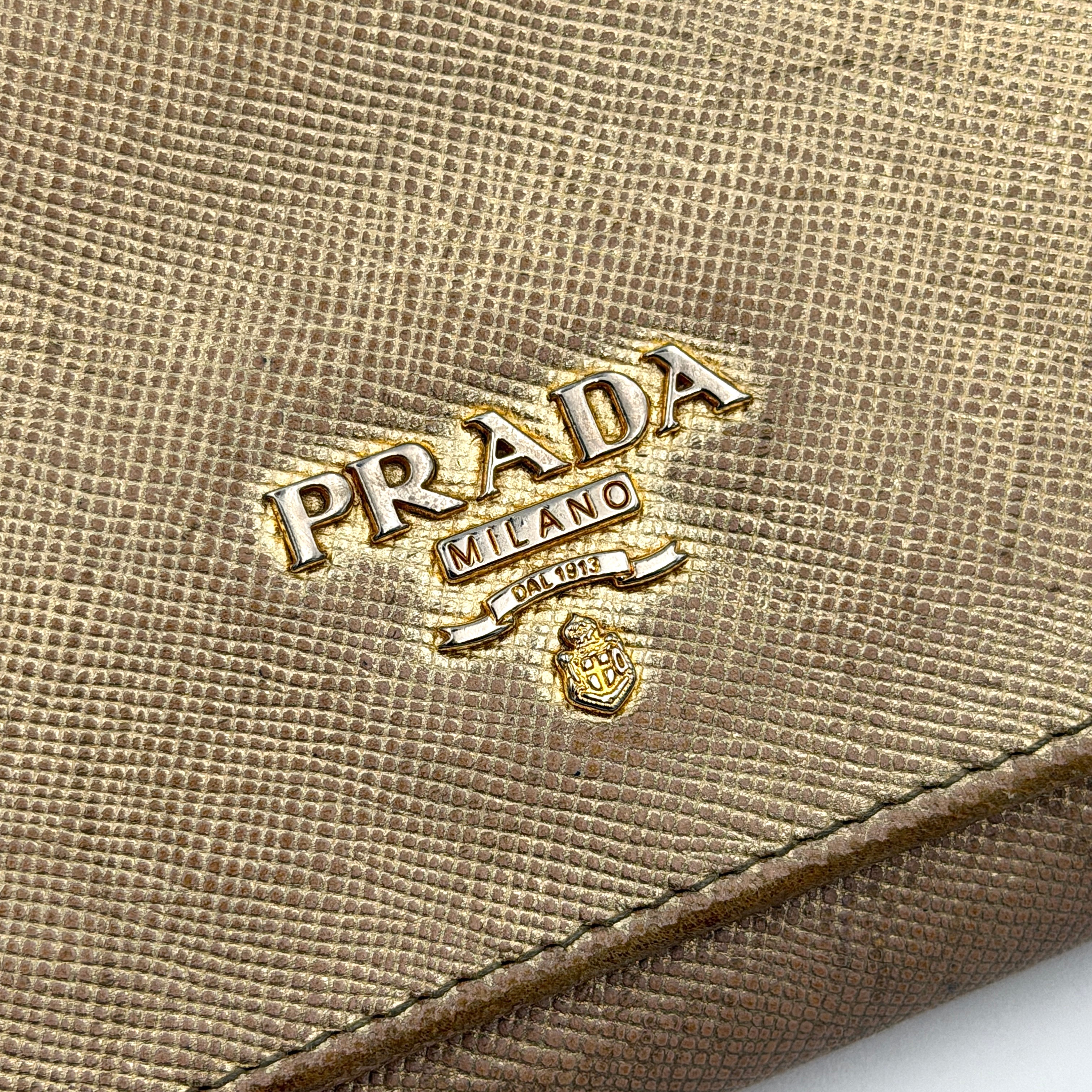 Prada Saffiano Continental Long Wallet in metallic gold Saffiano leather with gold-tone logo and structured silhouette.