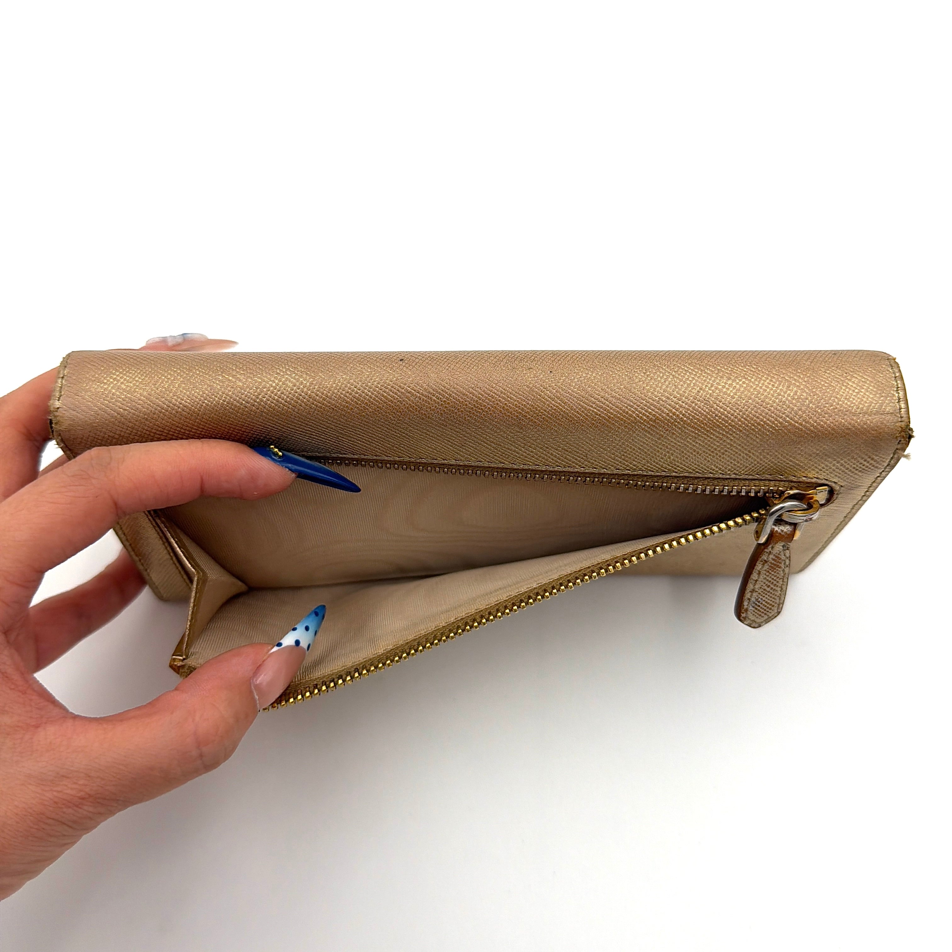 Prada Saffiano Continental Long Wallet in metallic gold Saffiano leather with gold-tone logo and structured silhouette.