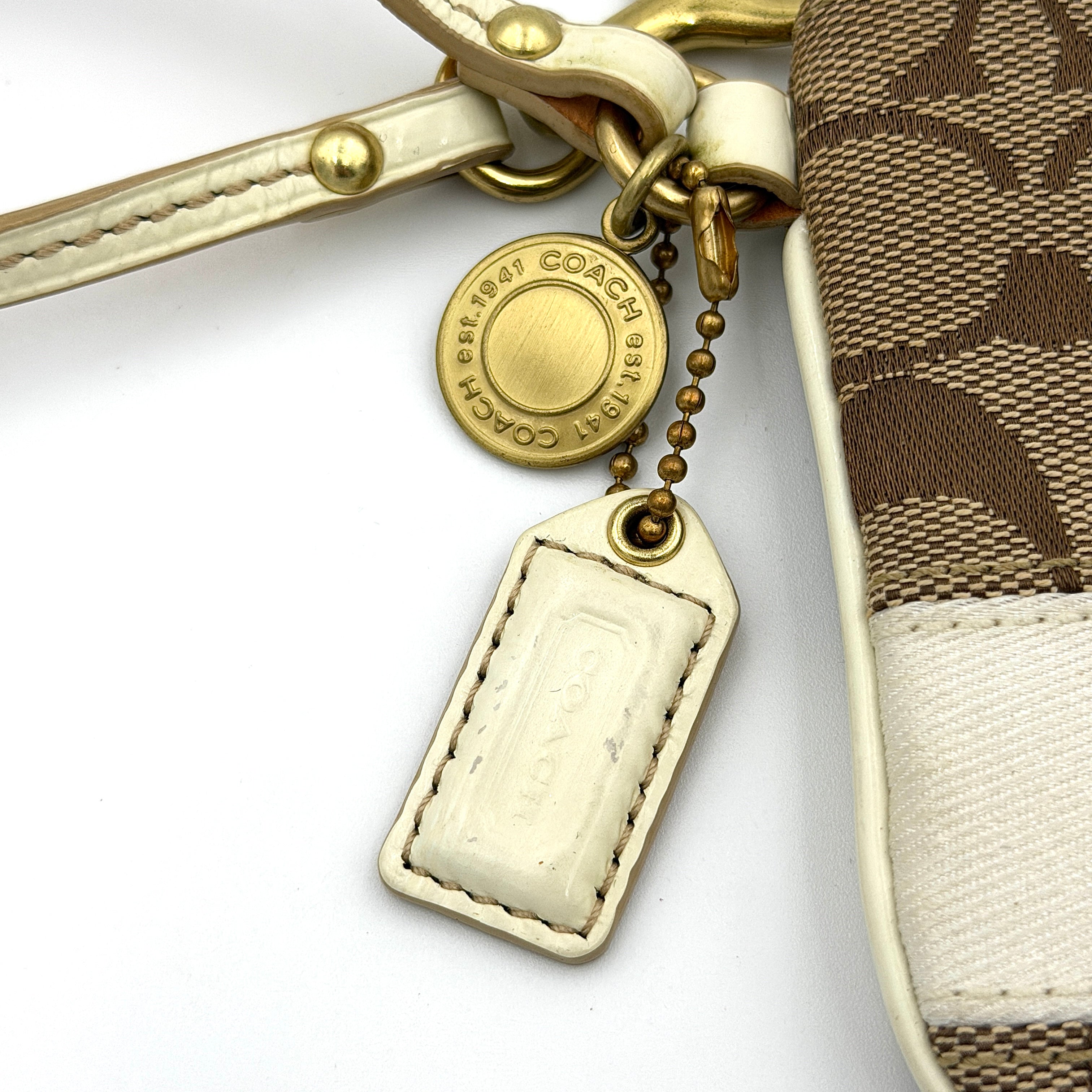 Coach Signature Stripe Wristlet in beige and cream jacquard, accented with a cream leather strap and gold-tone hardware.