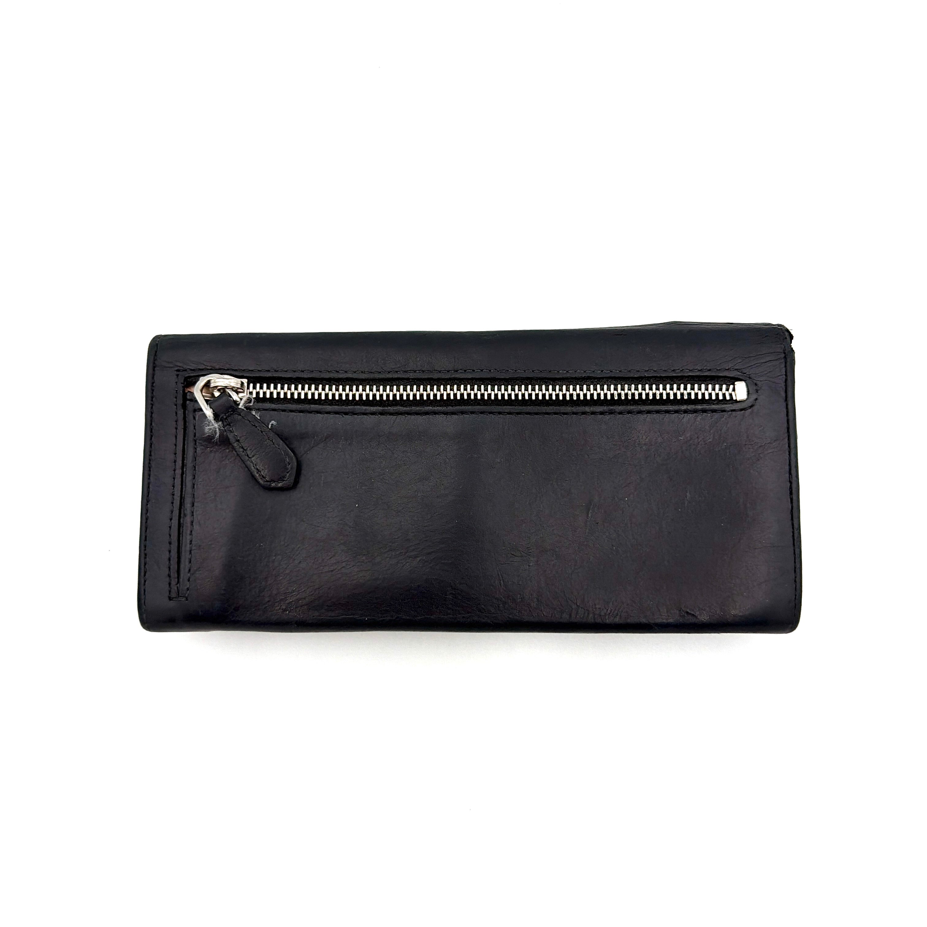 Prada Fiocco Bow Continental Wallet in black leather with a central grosgrain bow and silver-tone accents, displayed with refined simplicity.