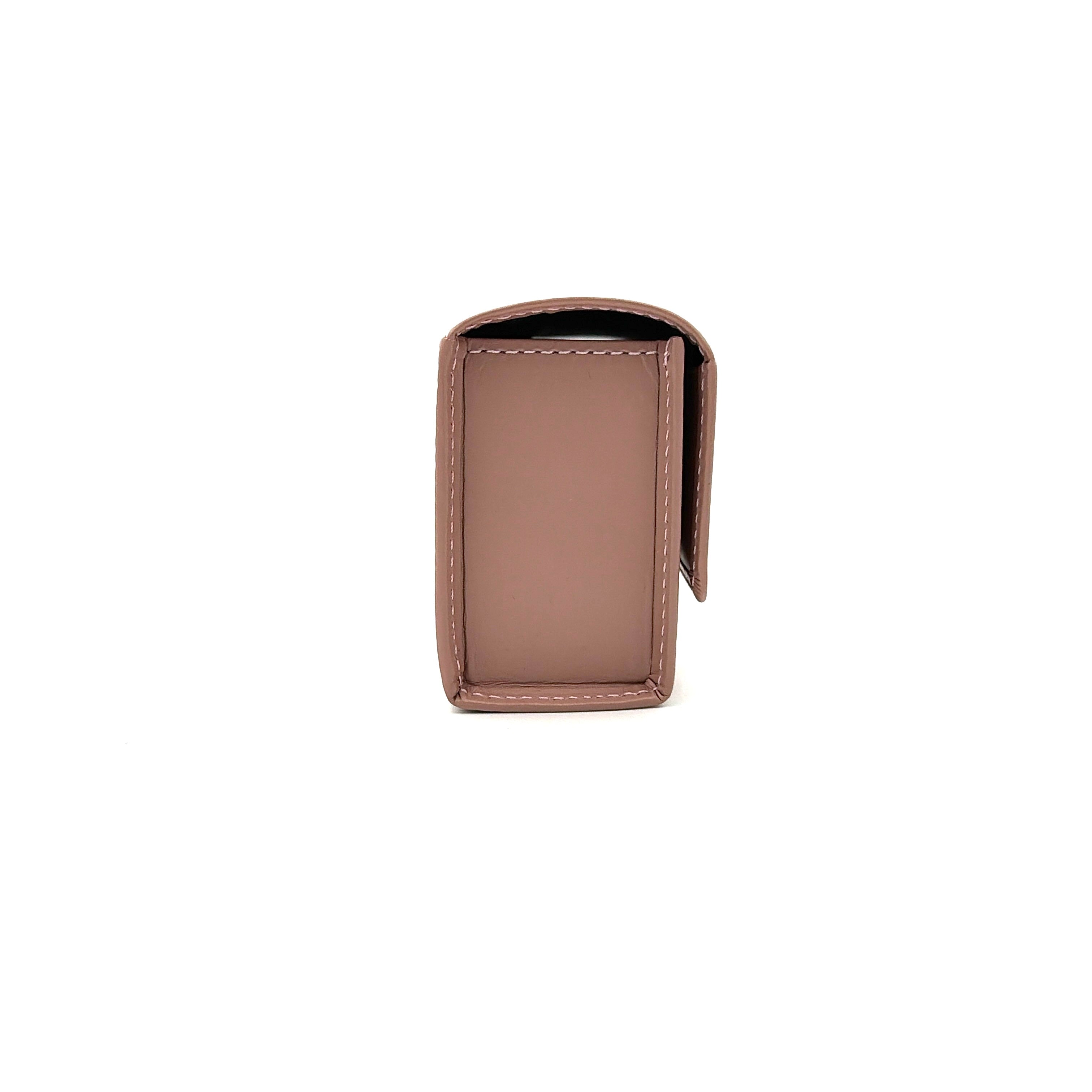 Vivienne Westwood pink leather wallet with silver signature Orb hardware, styled against a clean background.