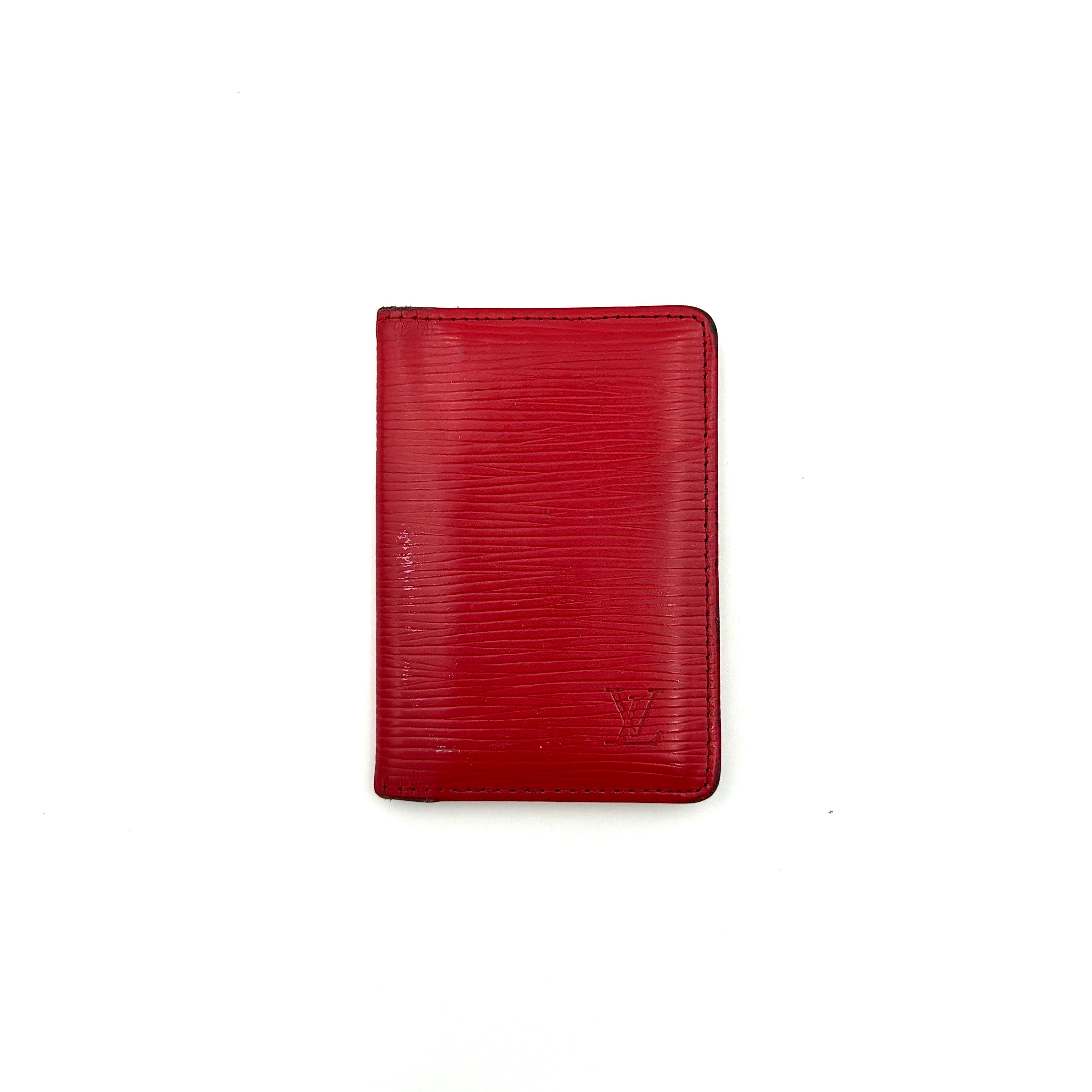 Front-facing view of the Louis Vuitton Epi Leather Pocket Organizer in a striking red, featuring subtle LV embossing and an elegant textured finish.