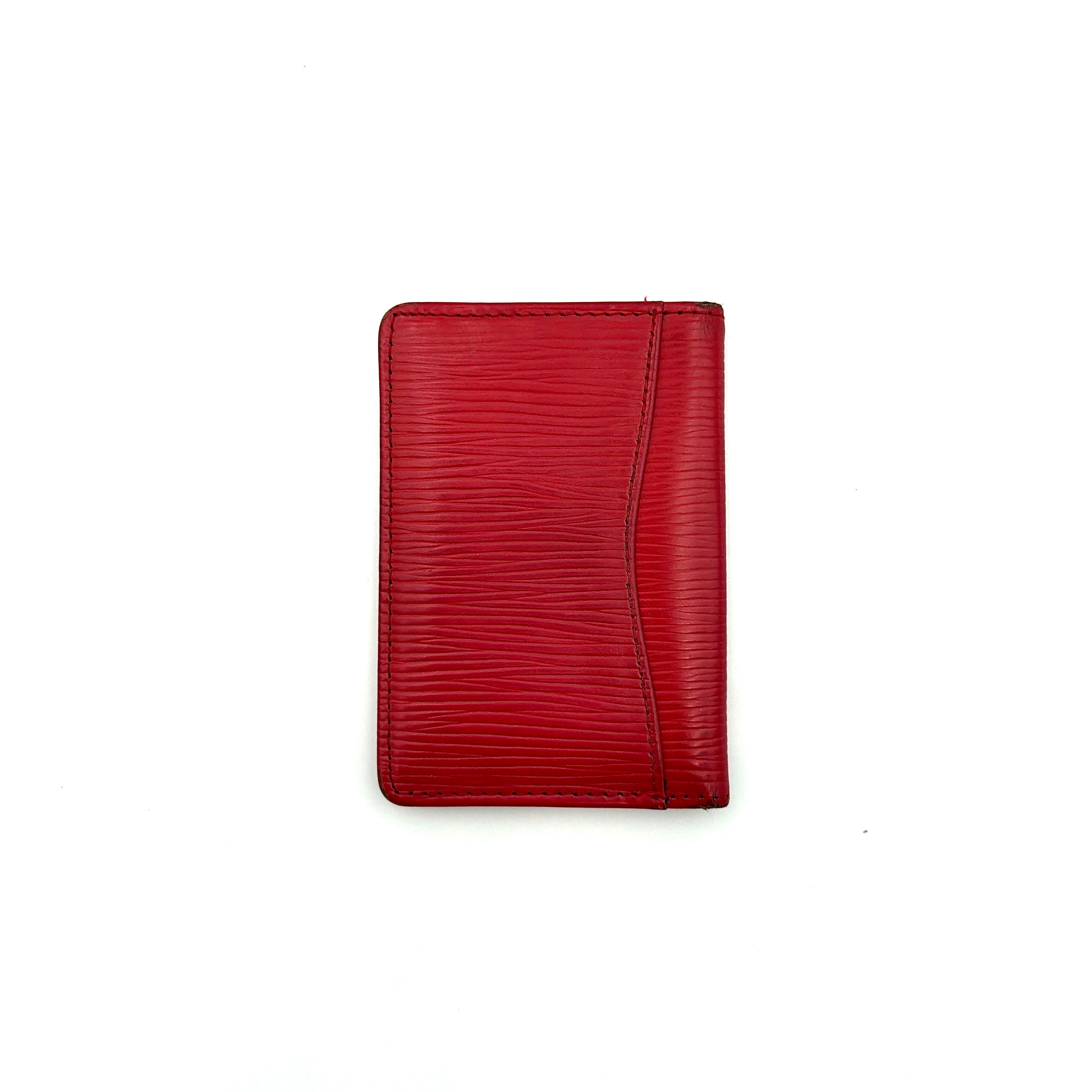Front-facing view of the Louis Vuitton Epi Leather Pocket Organizer in a striking red, featuring subtle LV embossing and an elegant textured finish.