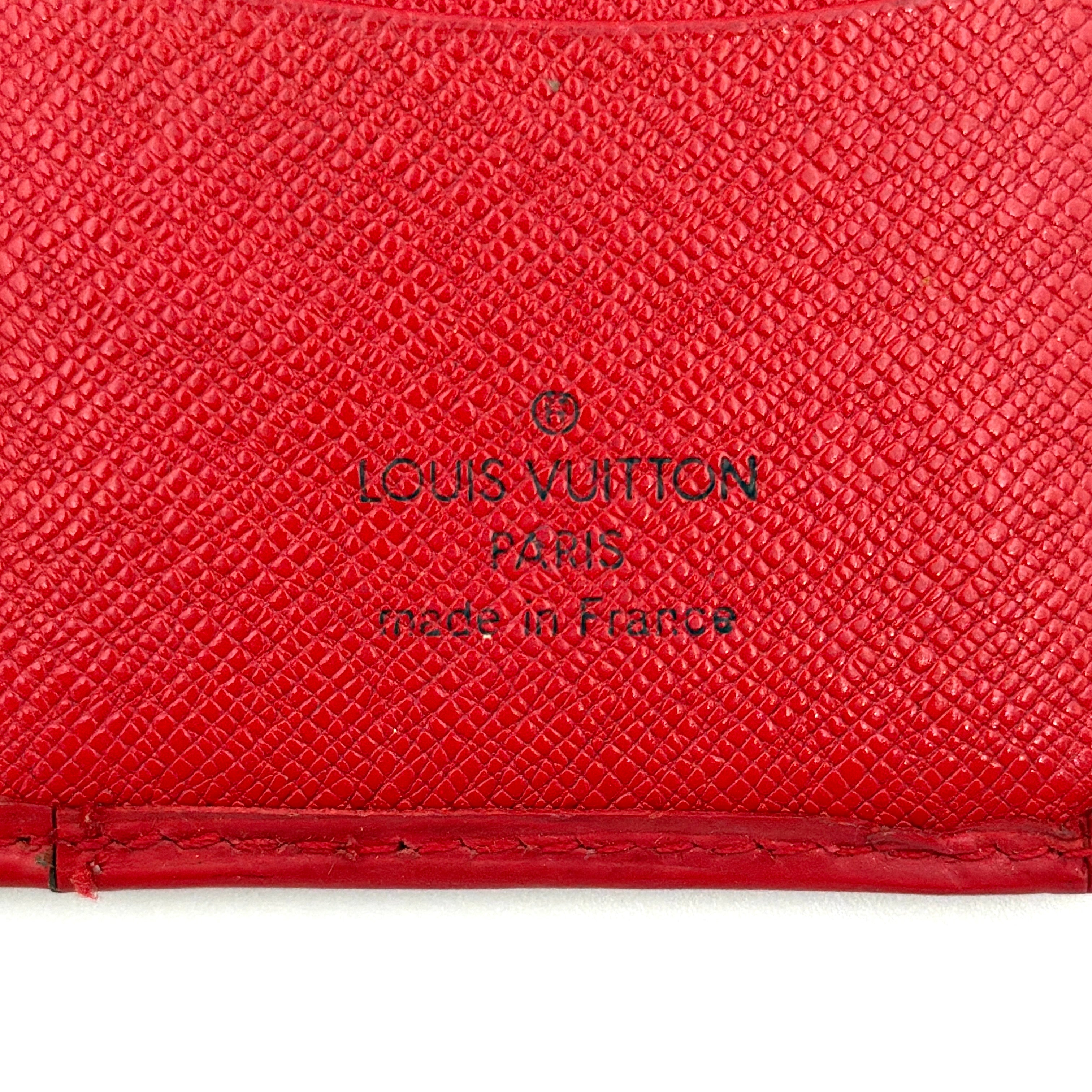 Front-facing view of the Louis Vuitton Epi Leather Pocket Organizer in a striking red, featuring subtle LV embossing and an elegant textured finish.