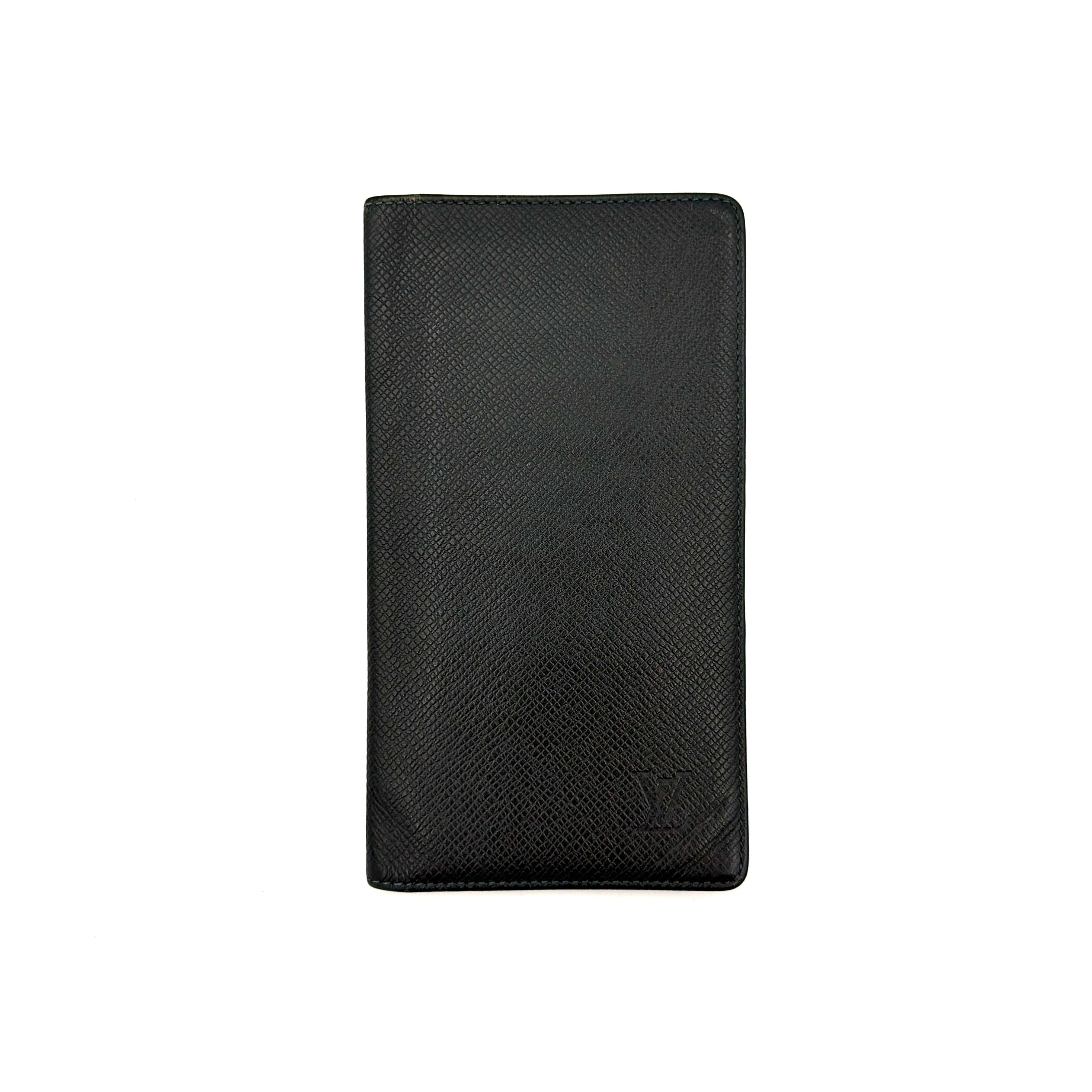 Louis Vuitton Taiga Brazza Wallet in dark green Taiga leather, showcasing a textured finish and iconic LV embossing in the bottom corner.