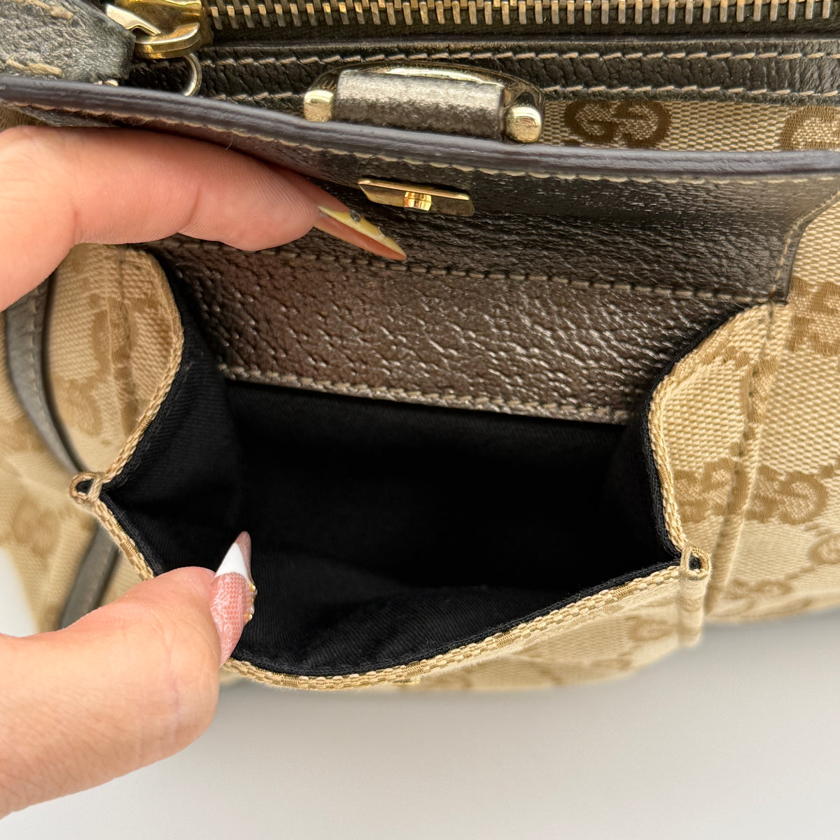 Gucci GG Monogram Abbey Pocket Tote Bag in beige and brown canvas with leather trim and front pockets, photographed against a white background.