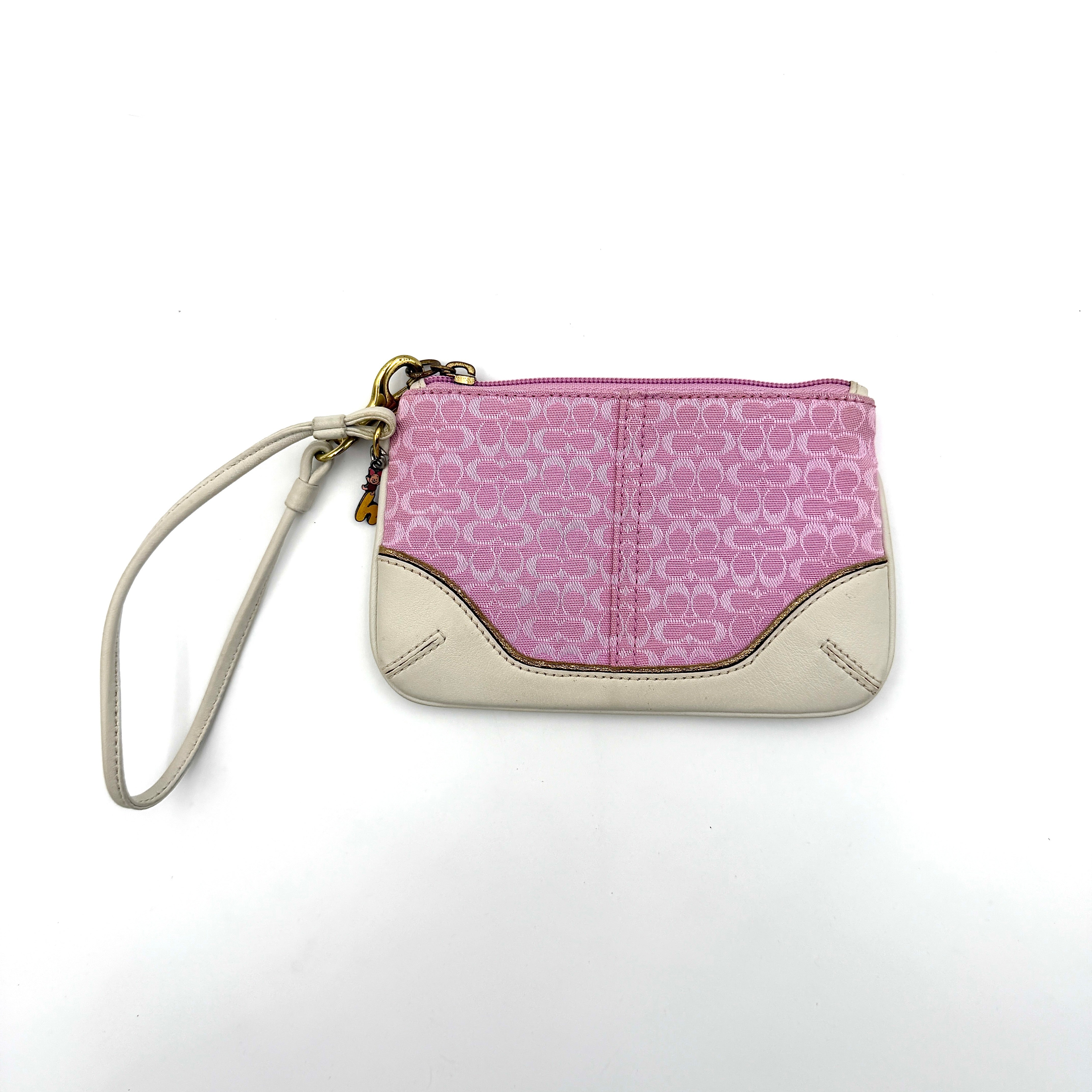 Coach Y2K Signature Canvas Wristlet in pink with white leather trim and a whimsical Piglet charm detail.
