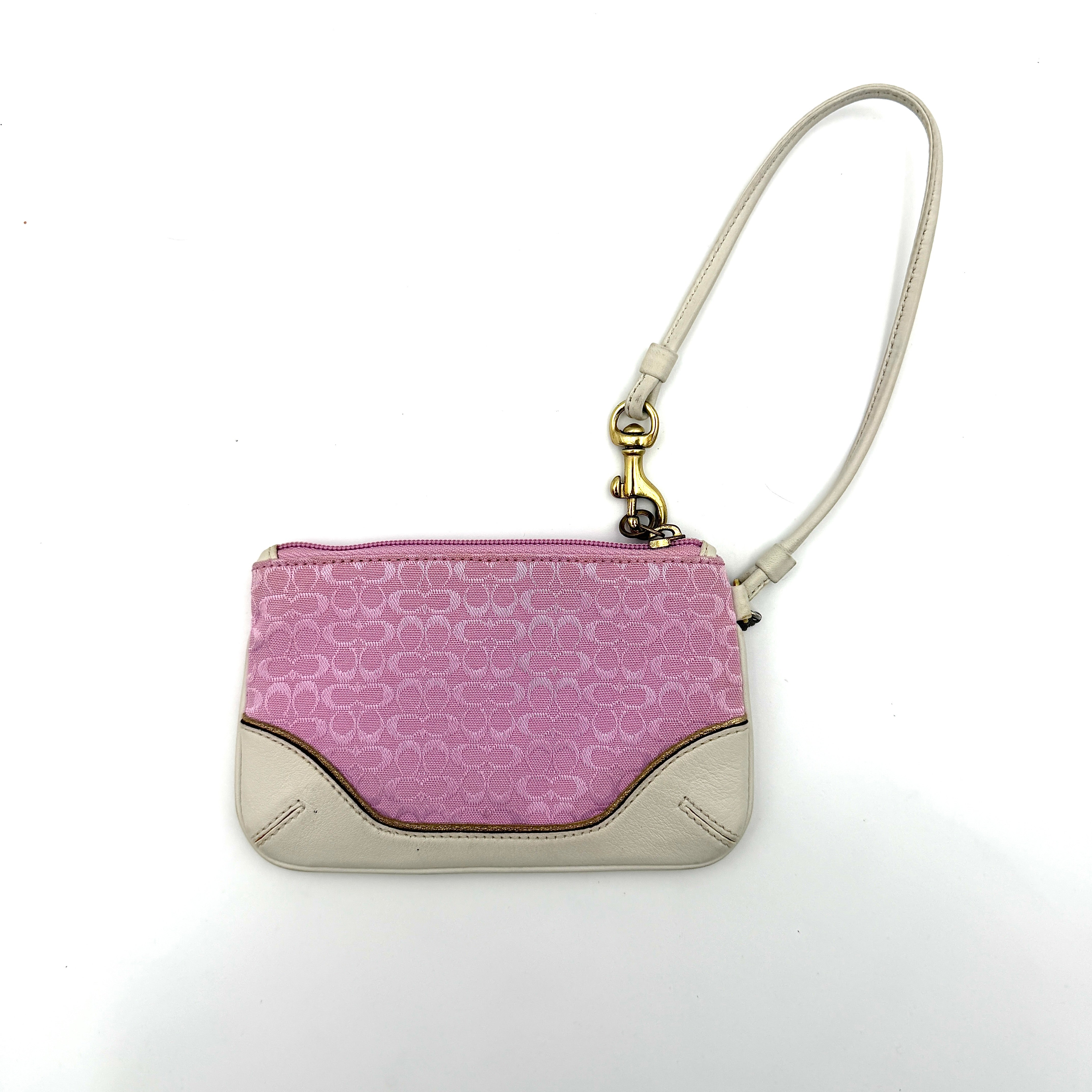 Coach Y2K Signature Canvas Wristlet in pink with white leather trim and a whimsical Piglet charm detail.