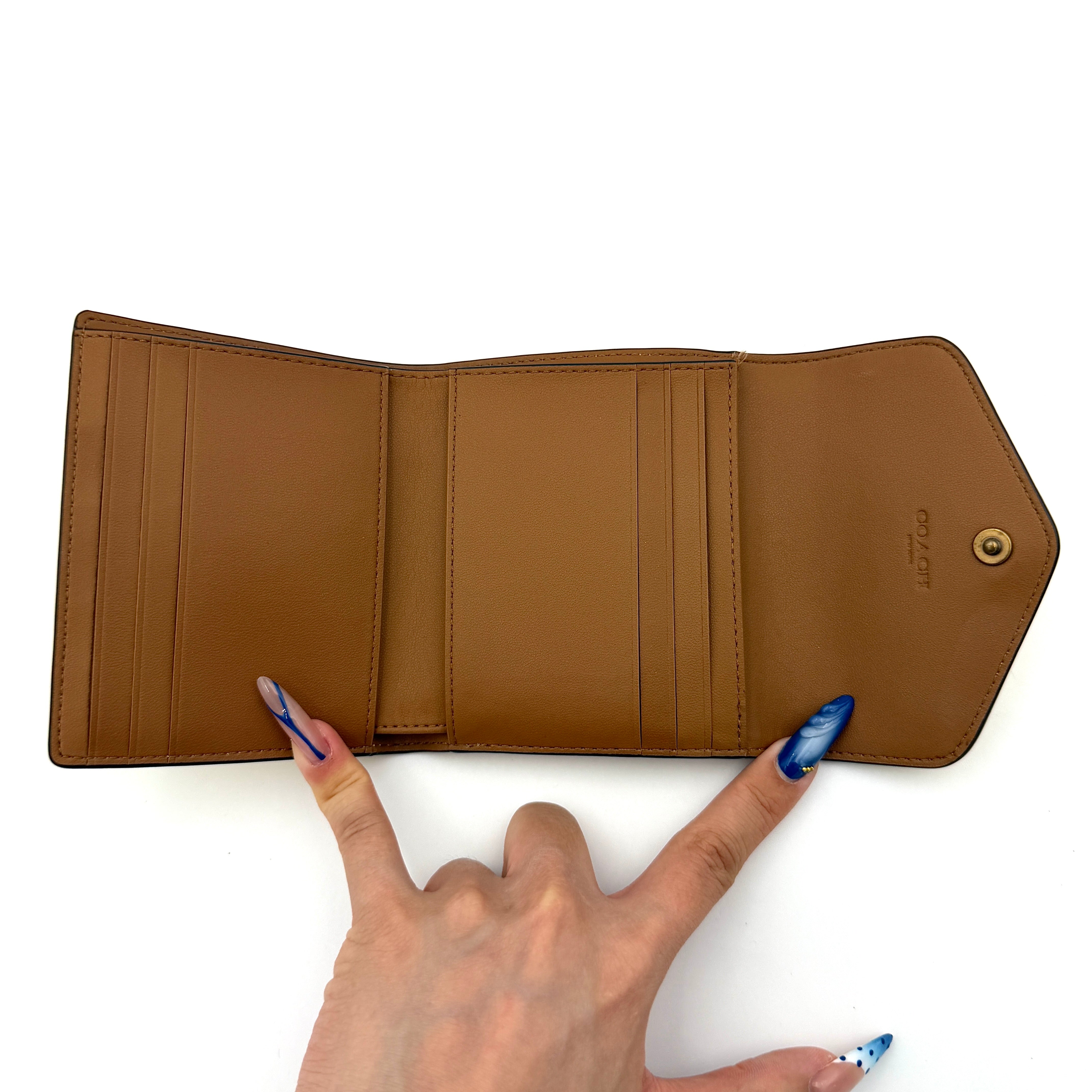 Coach Wyn Small Wallet in vibrant yellow leather with gold-tone 'C' detail on the envelope flap.