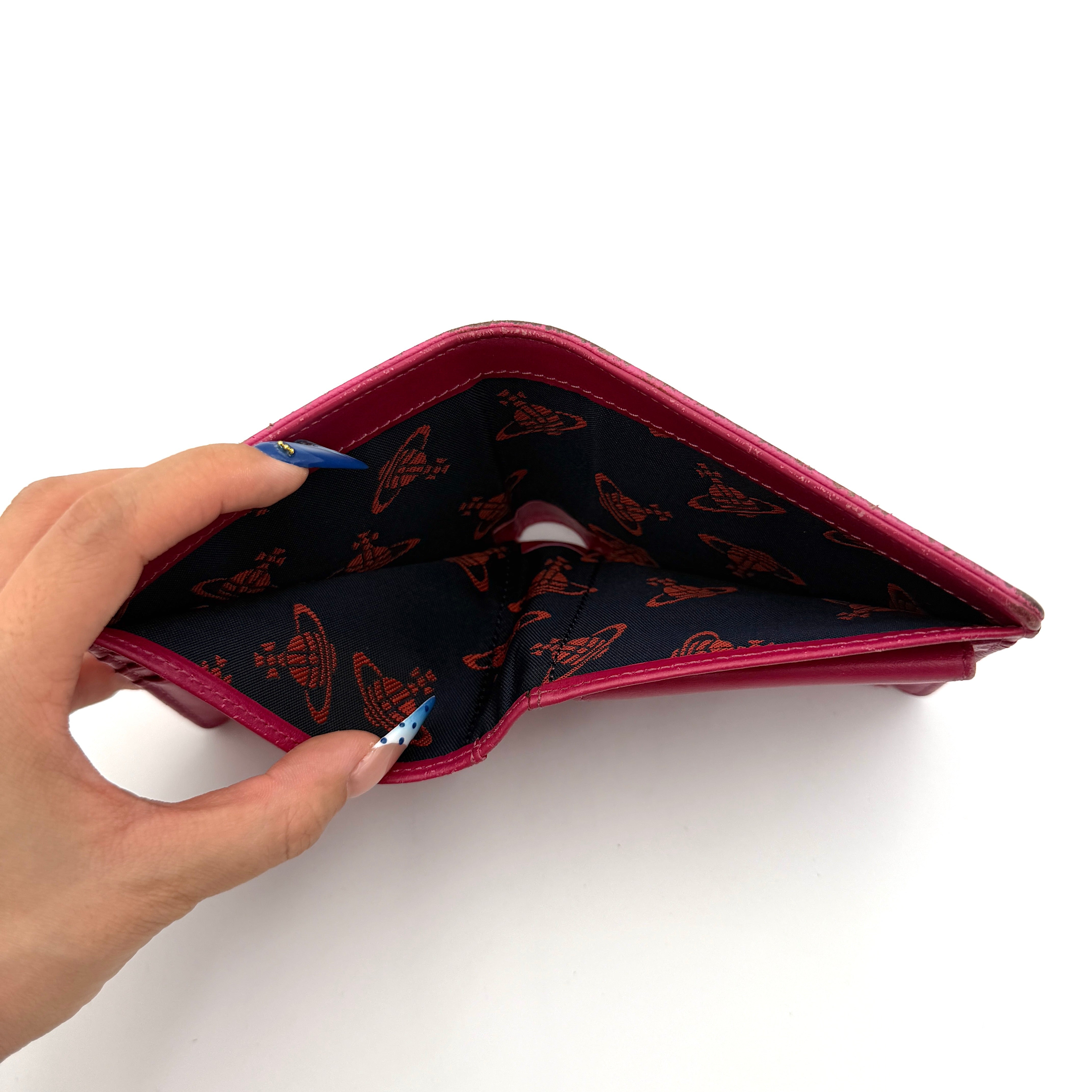 Vivienne Westwood Orb Saffiano Wallet in brilliant pink with gold-tone Orb emblem and cross-grained leather texture.