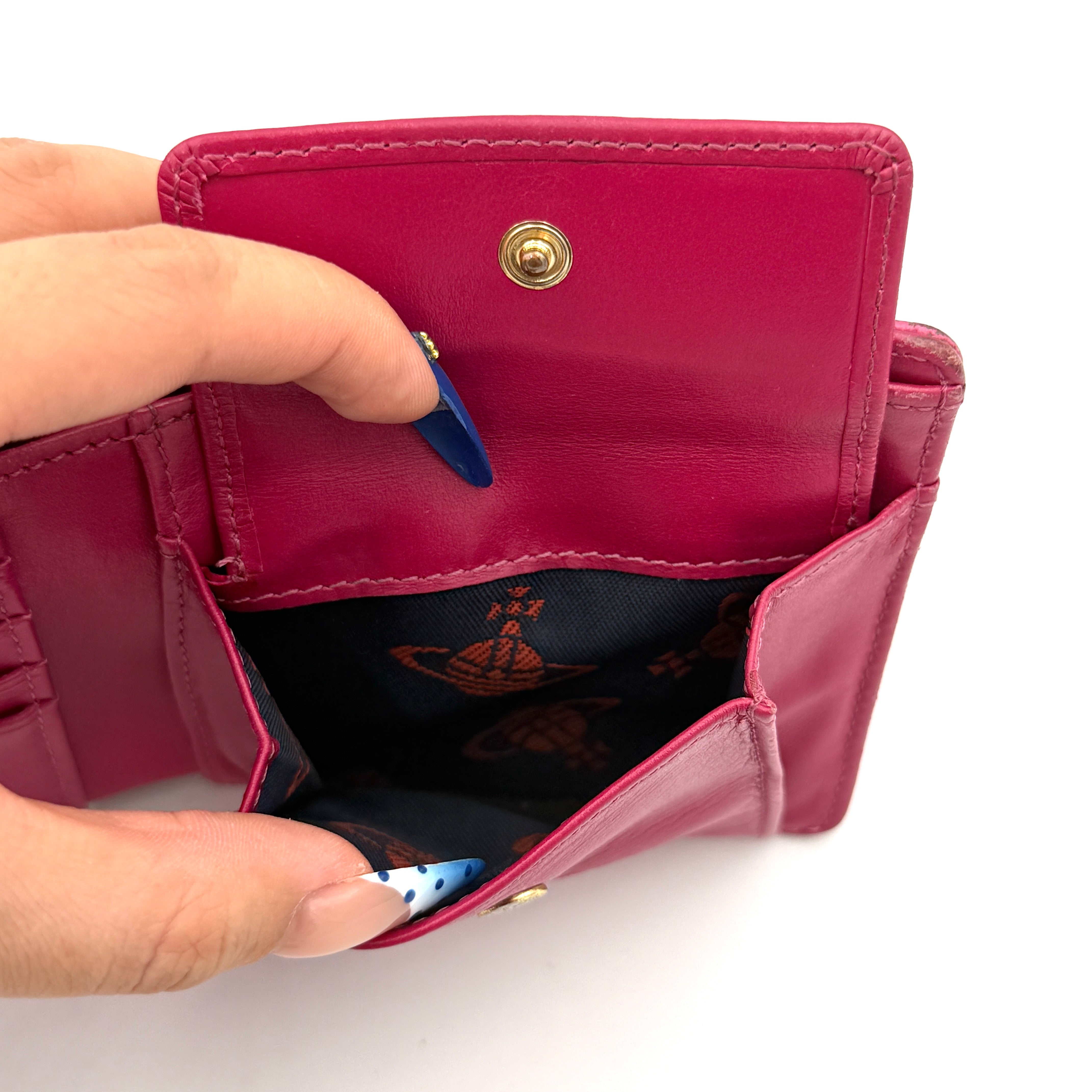 Vivienne Westwood Orb Saffiano Wallet in brilliant pink with gold-tone Orb emblem and cross-grained leather texture.