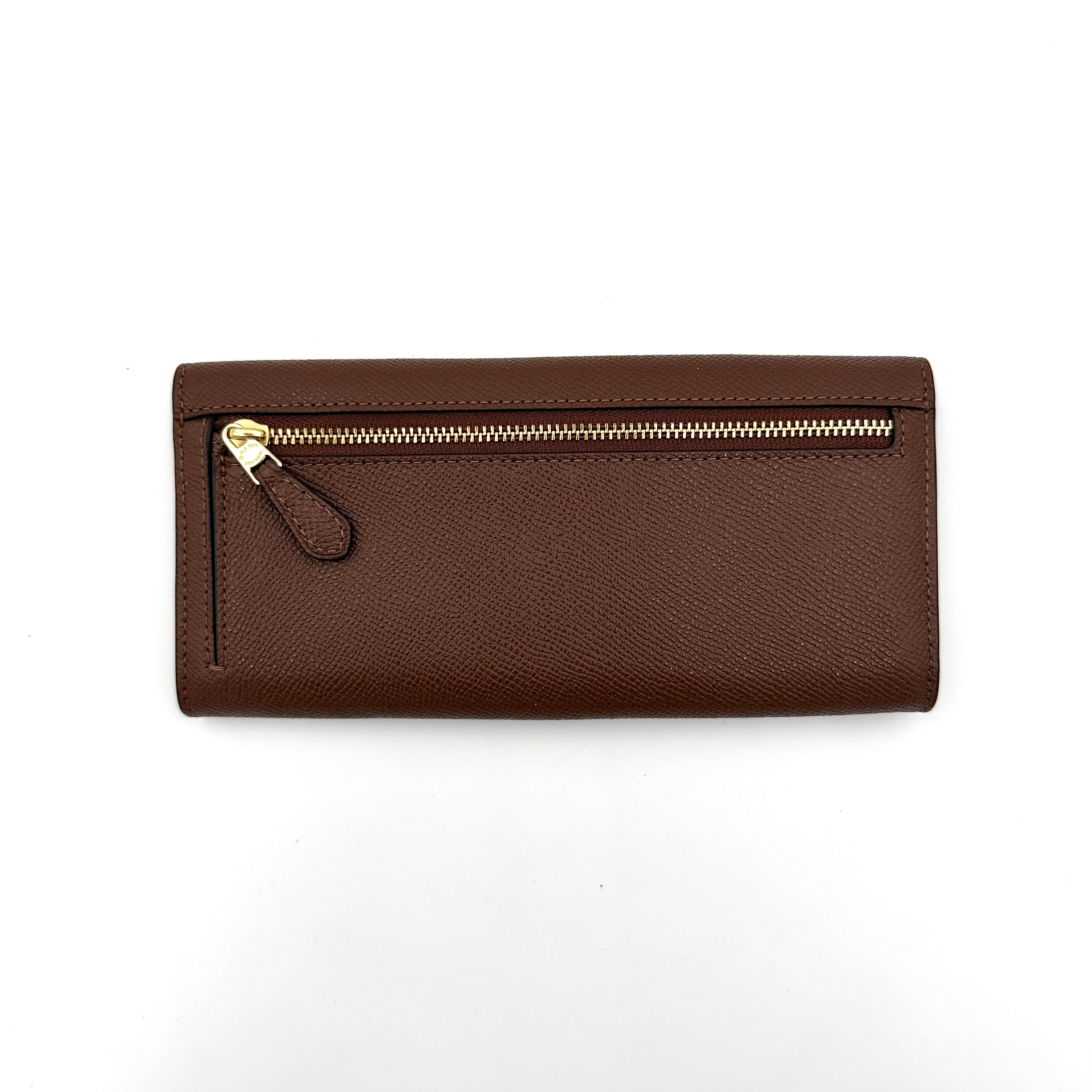 Coach brown envelope long wallet in textured leather with gold hardware, shown closed with the signature horse and carriage logo.
