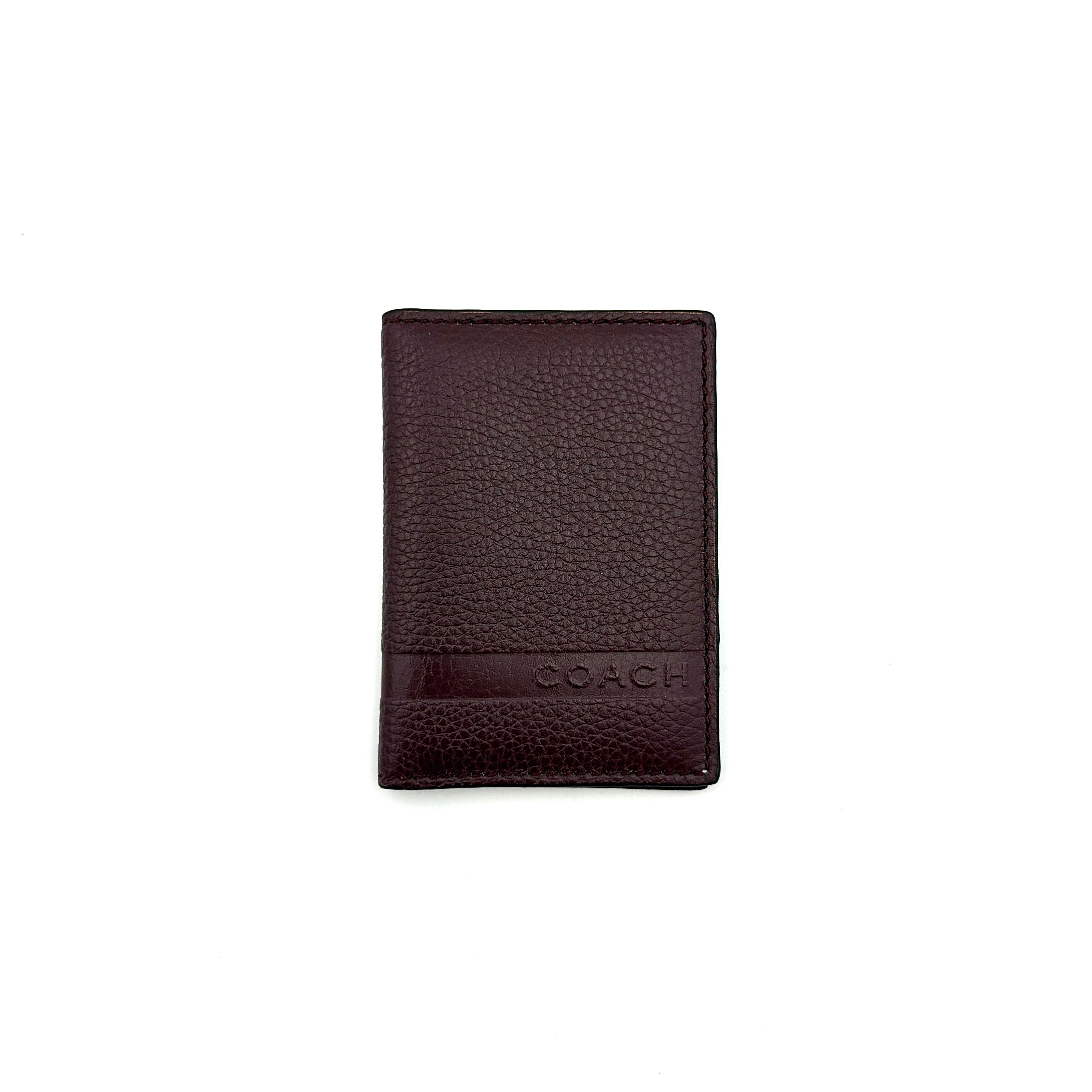 Coach Camden Slim Card Holder in burgundy pebbled leather with embossed logo and sleek bifold silhouette.