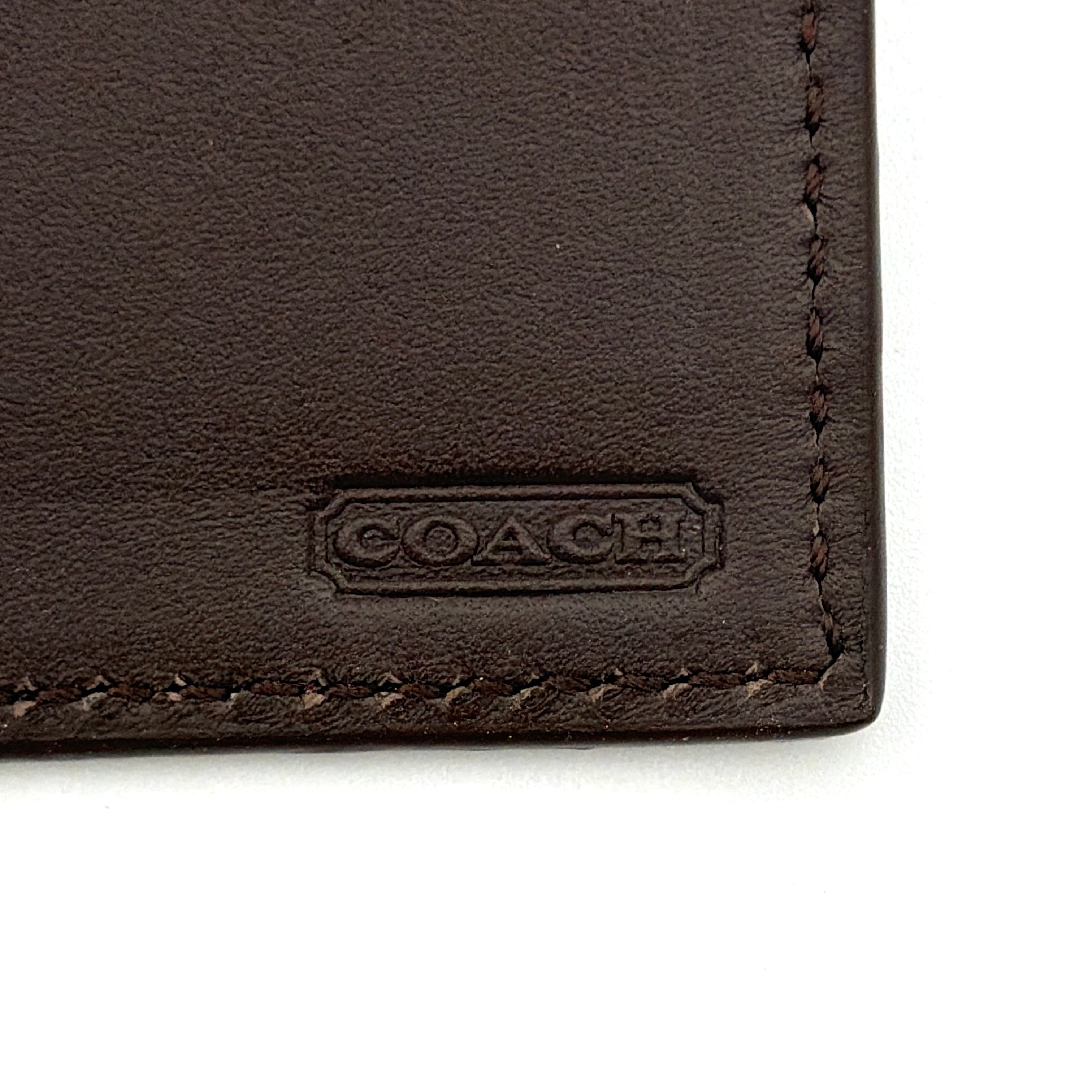 Coach Camden Slim Card Holder in burgundy pebbled leather with embossed logo and sleek bifold silhouette.