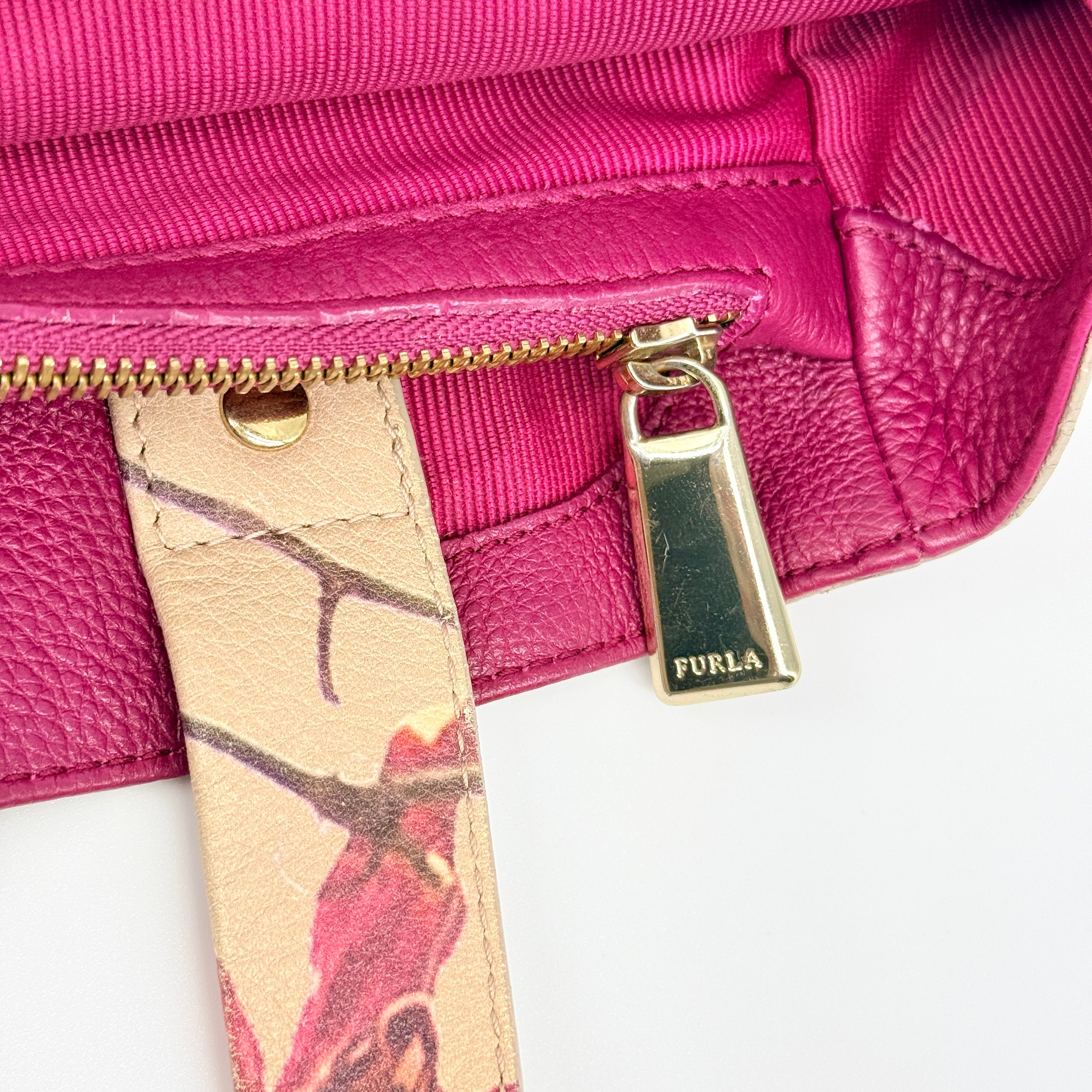 Furla beige leather tote bag adorned with a bold magenta and plum floral print, featuring structured short handles.