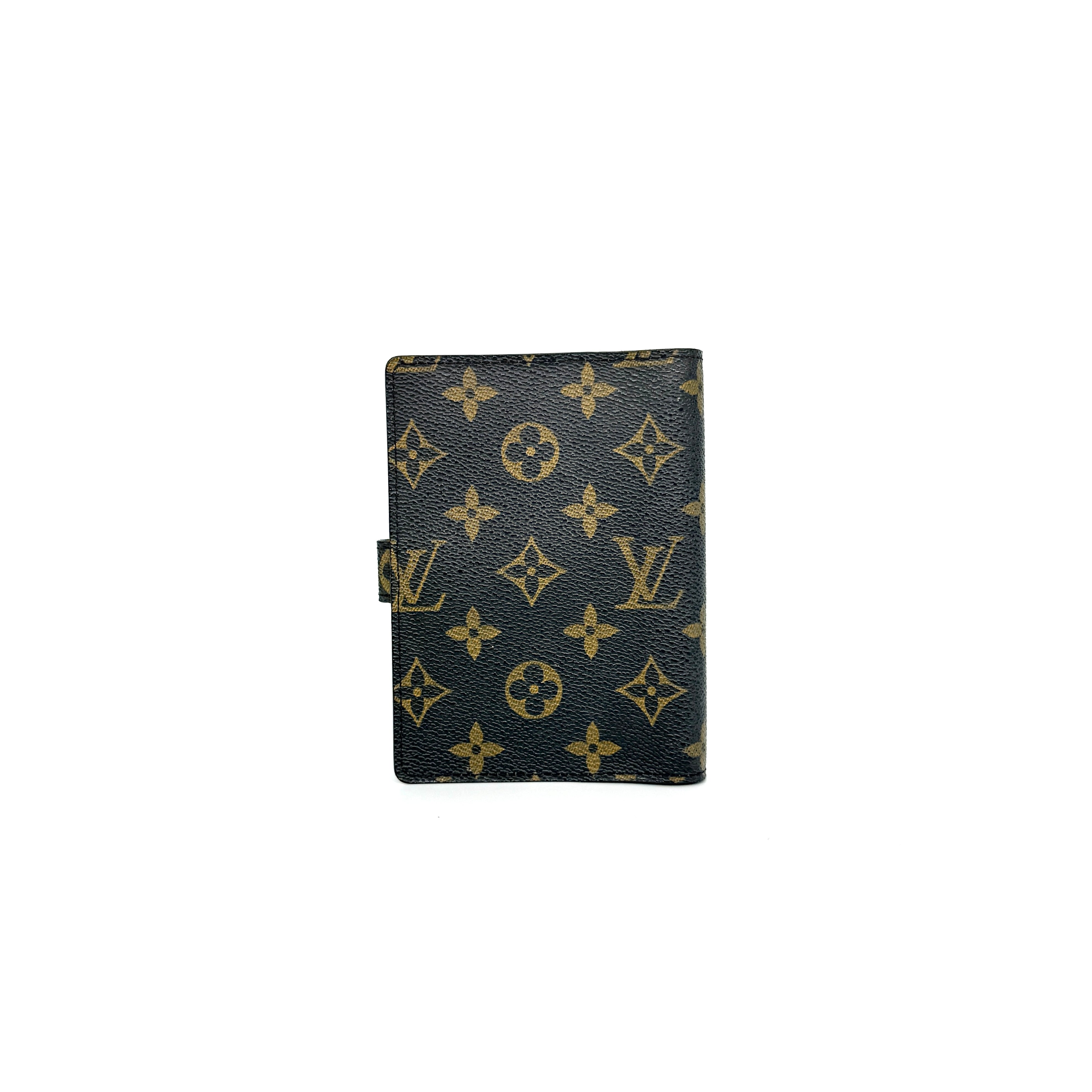 Louis Vuitton Monogram Agenda Cover in brown canvas with gold snap closure, displayed against a white background.