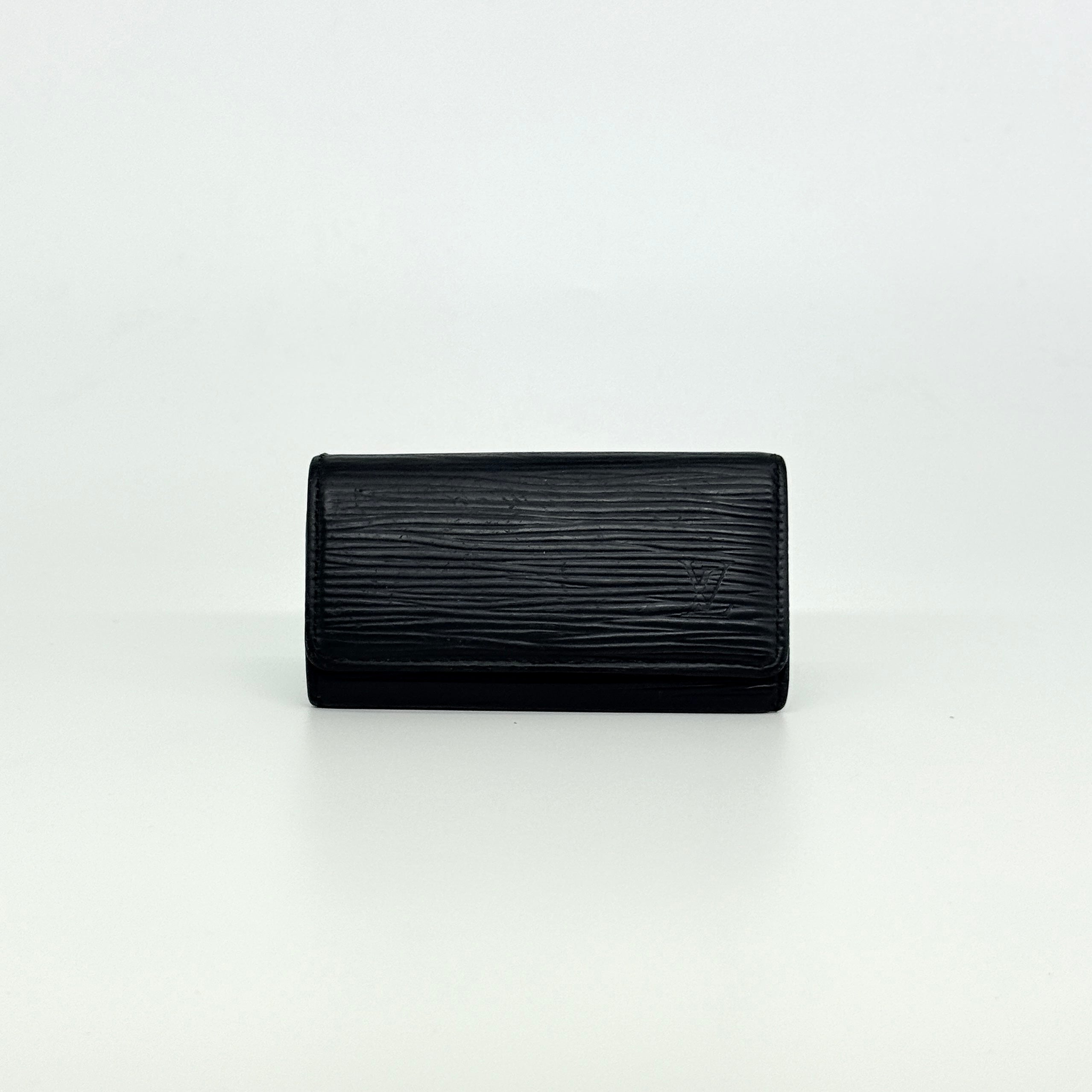Louis Vuitton Epi Leather key case in black with silver-tone key hooks and snap closure, photographed against a clean white background.