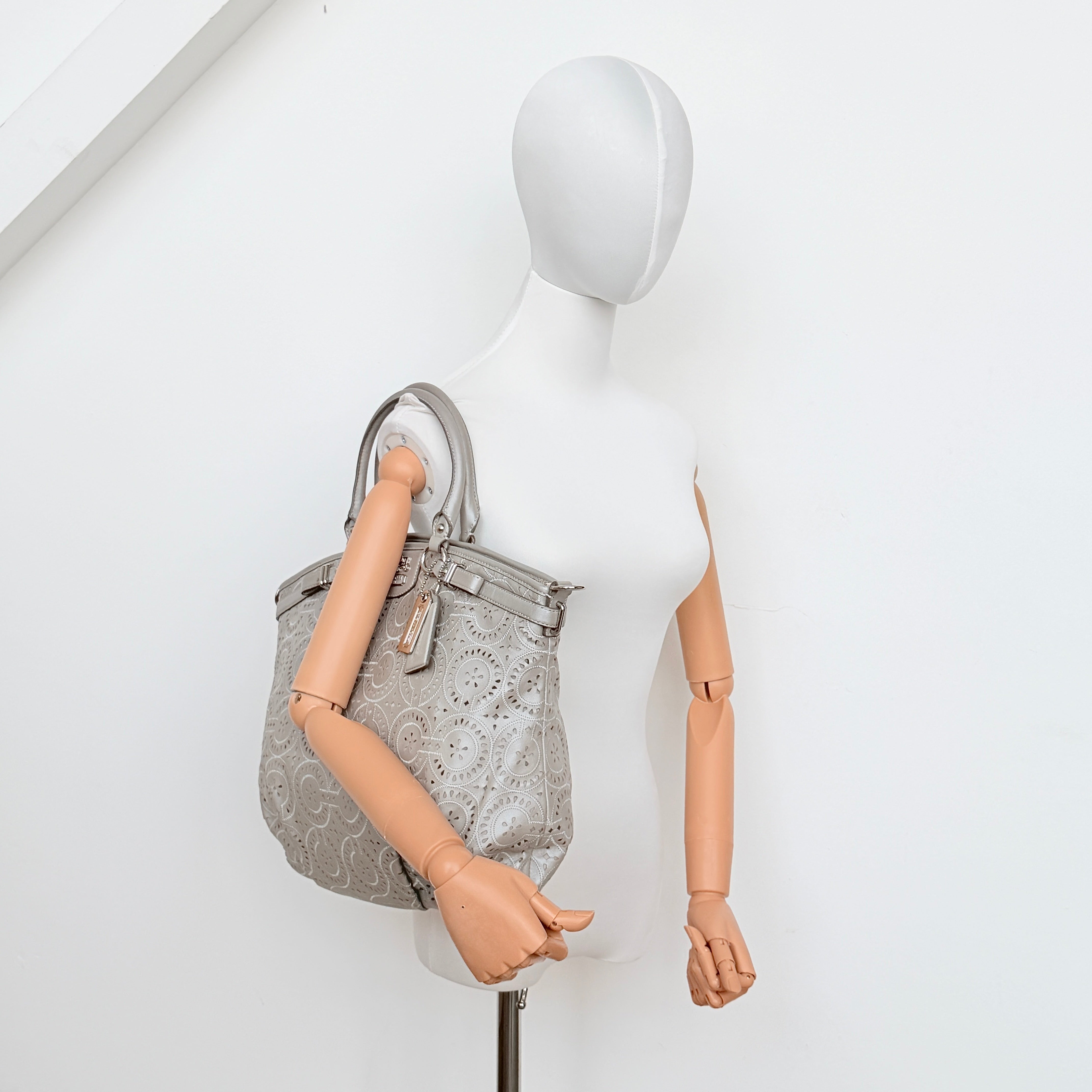 Coach Madison Sophia Shoulder Bag in silver leather with intricate cutout details, shown with original dust bag and detachable strap.