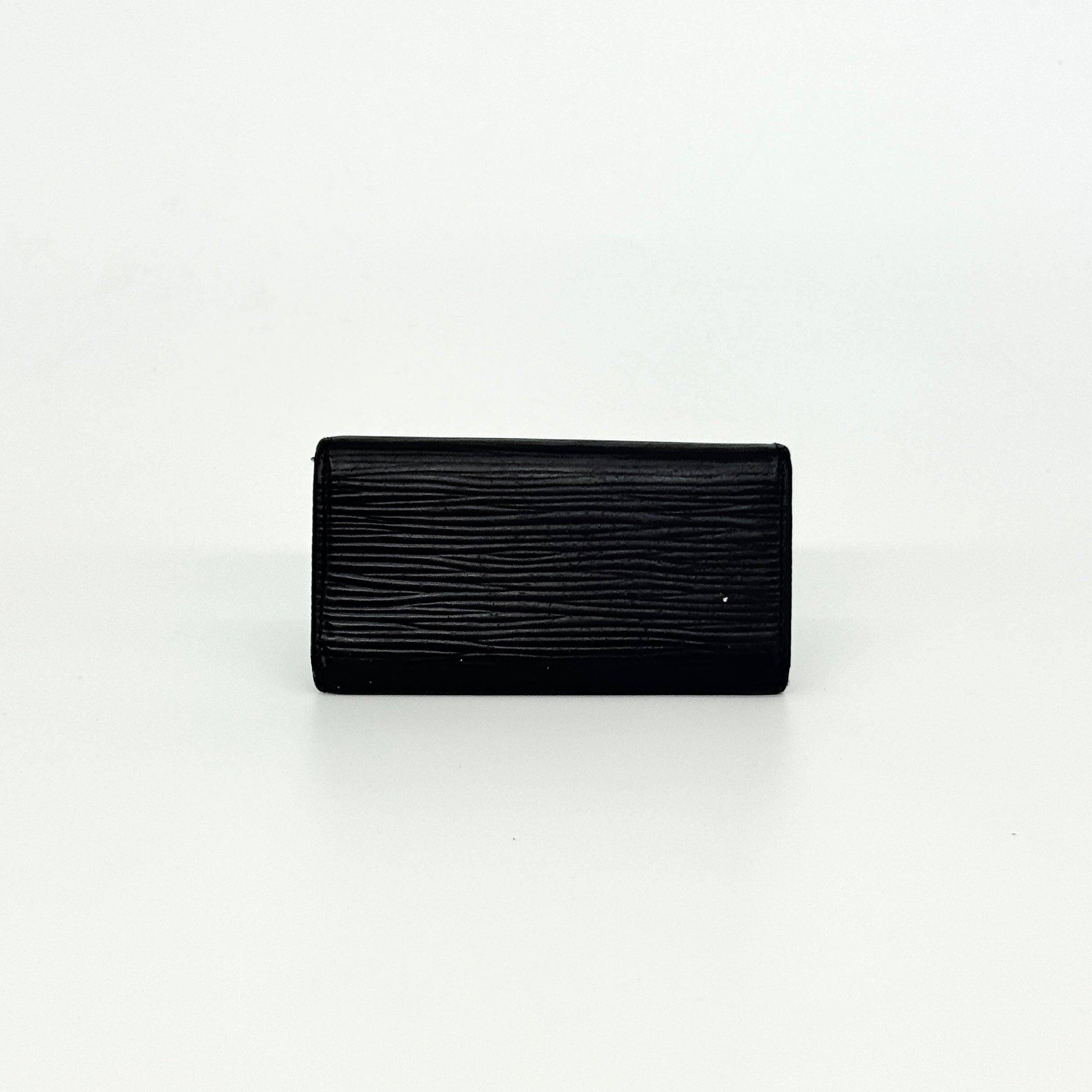 Louis Vuitton Epi Leather key case in black with silver-tone key hooks and snap closure, photographed against a clean white background.