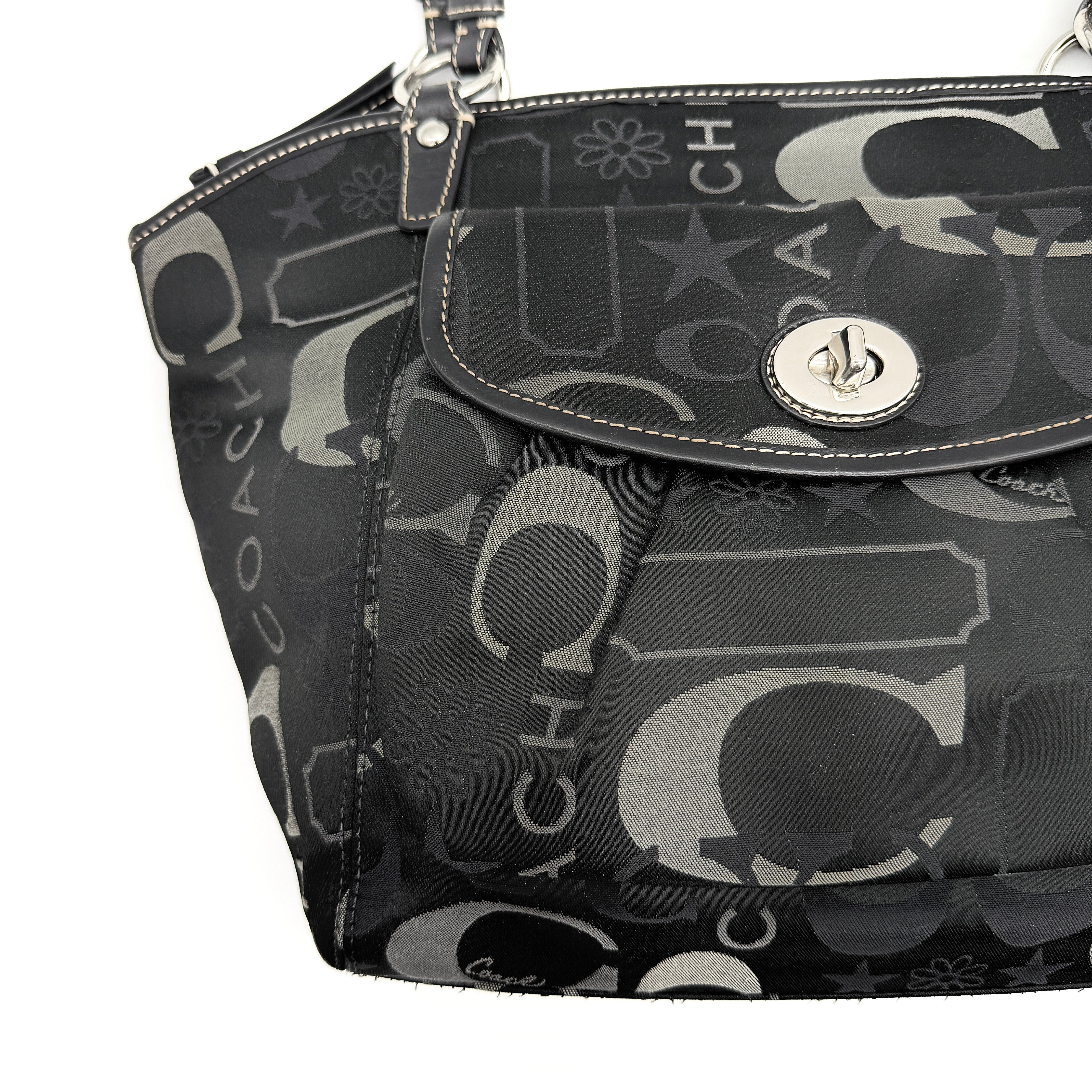 Coach Signature Leah Shoulder Bag in black jacquard with silver-tone hardware and bold logo pattern.