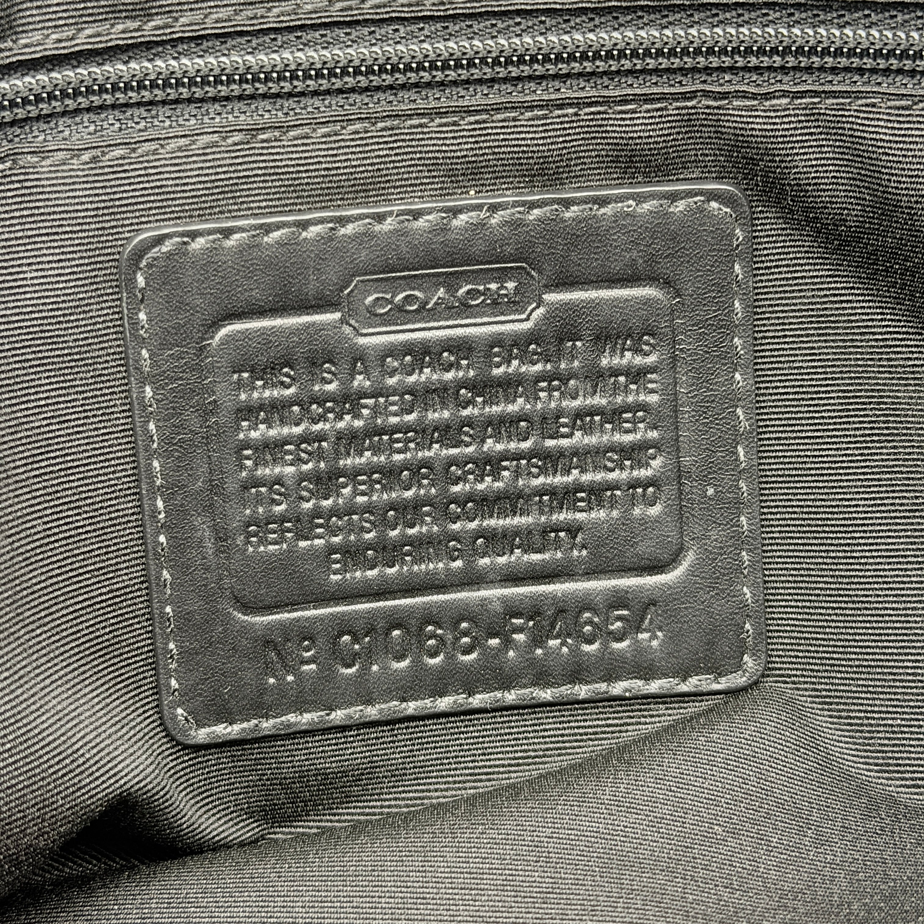 Coach Signature Leah Shoulder Bag in black jacquard with silver-tone hardware and bold logo pattern.