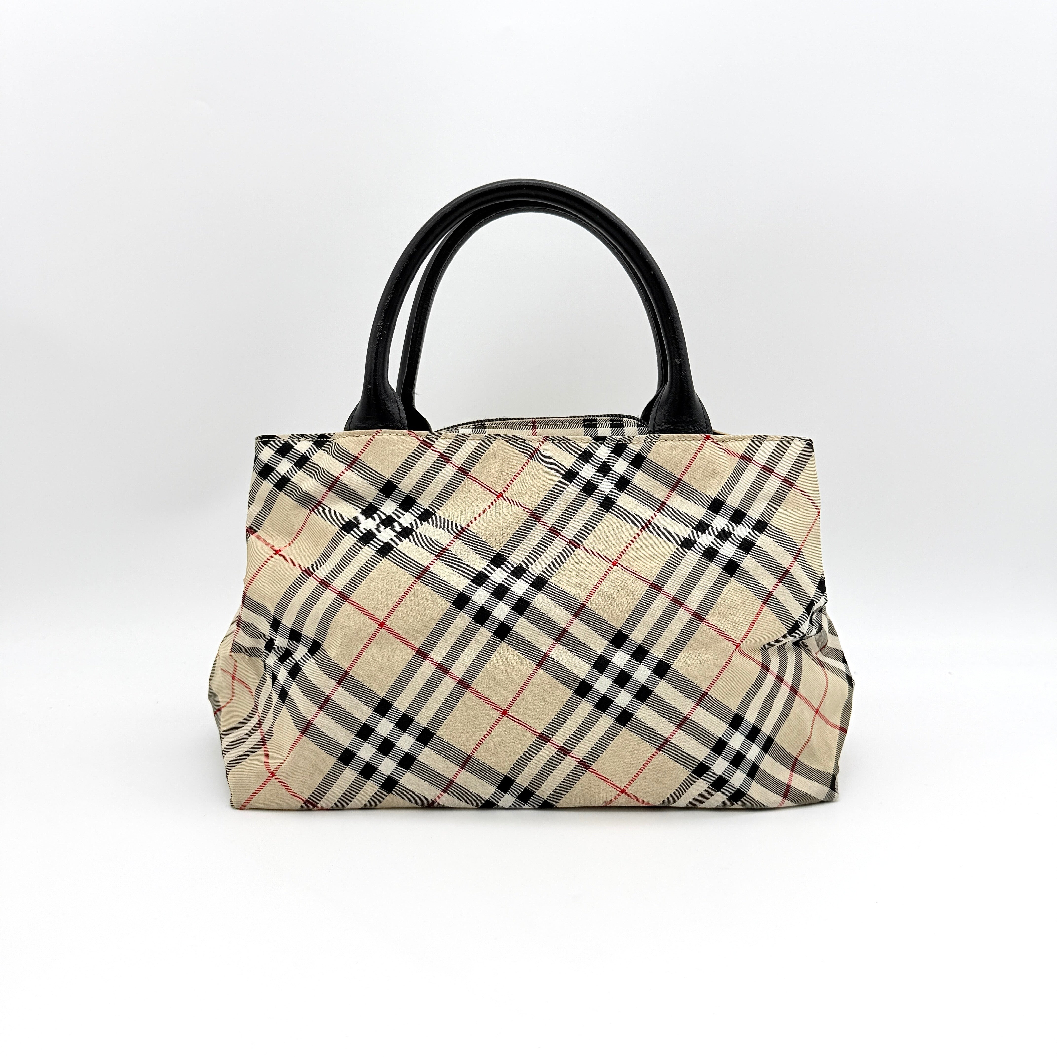 Burberry Blue Label Nova Check nylon shoulder bag in beige and black with leather handles, displayed against a white background.