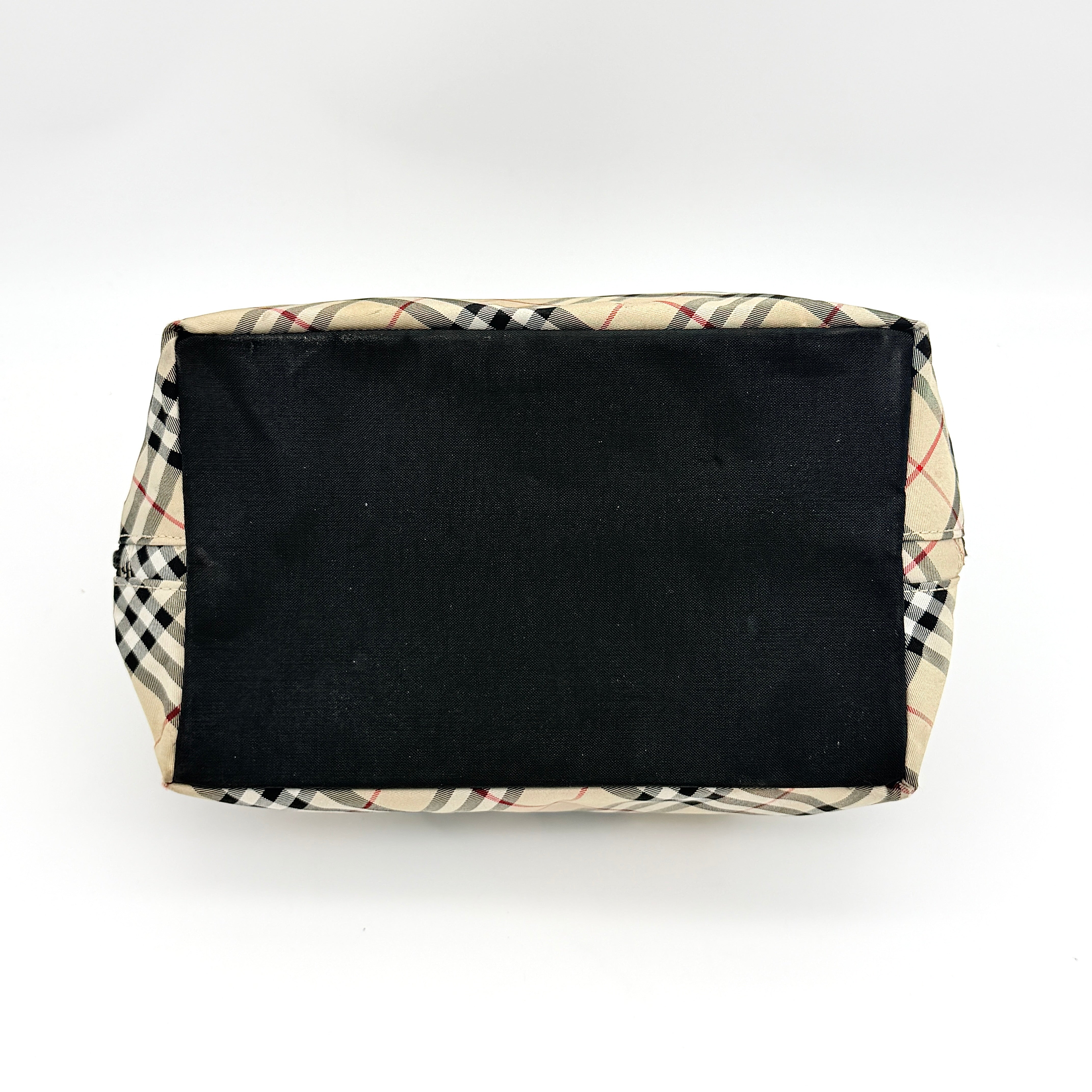 Burberry Blue Label Nova Check nylon shoulder bag in beige and black with leather handles, displayed against a white background.
