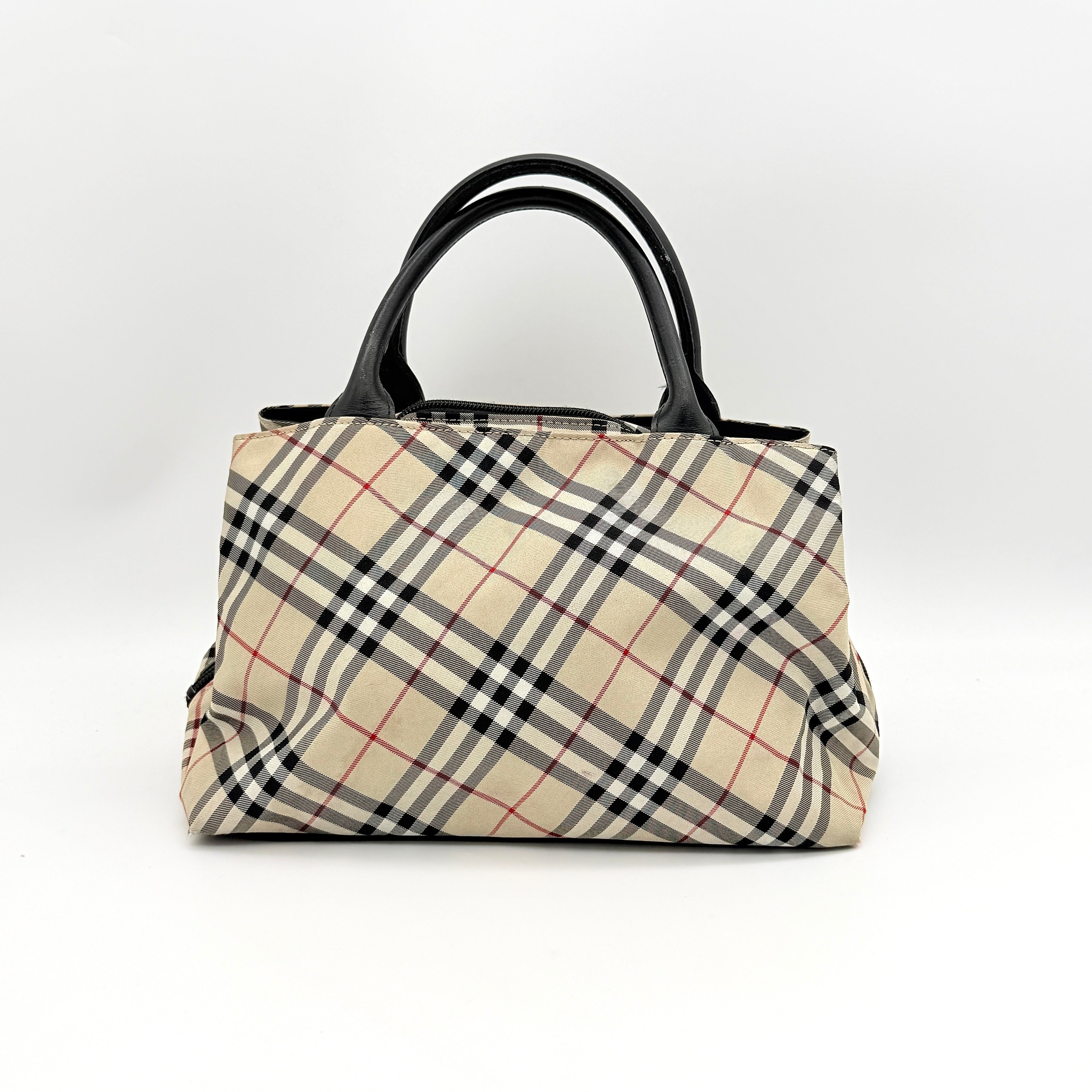 Burberry Blue Label Nova Check nylon shoulder bag in beige and black with leather handles, displayed against a white background.