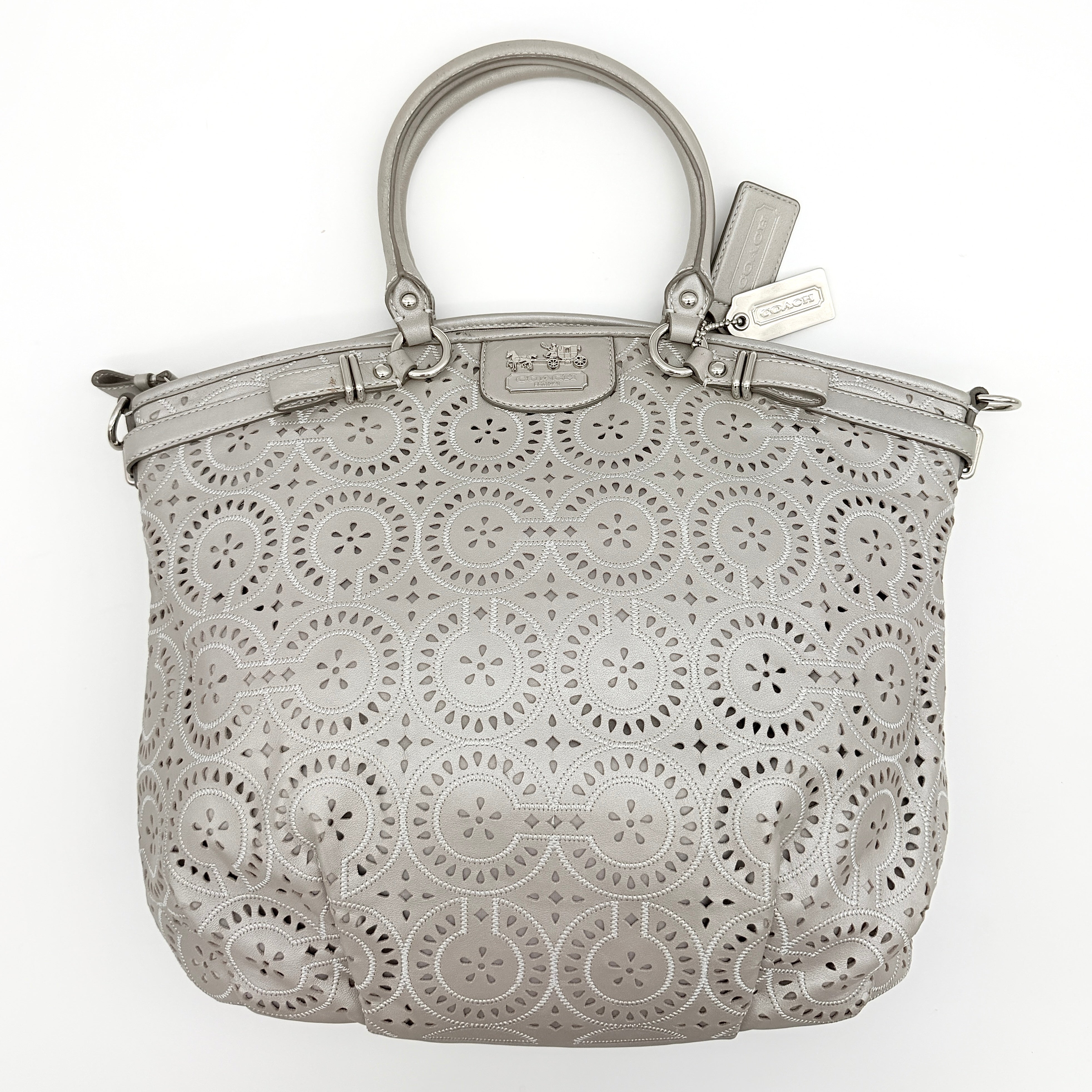 Coach Madison Sophia Shoulder Bag in silver leather with intricate cutout details, shown with original dust bag and detachable strap.