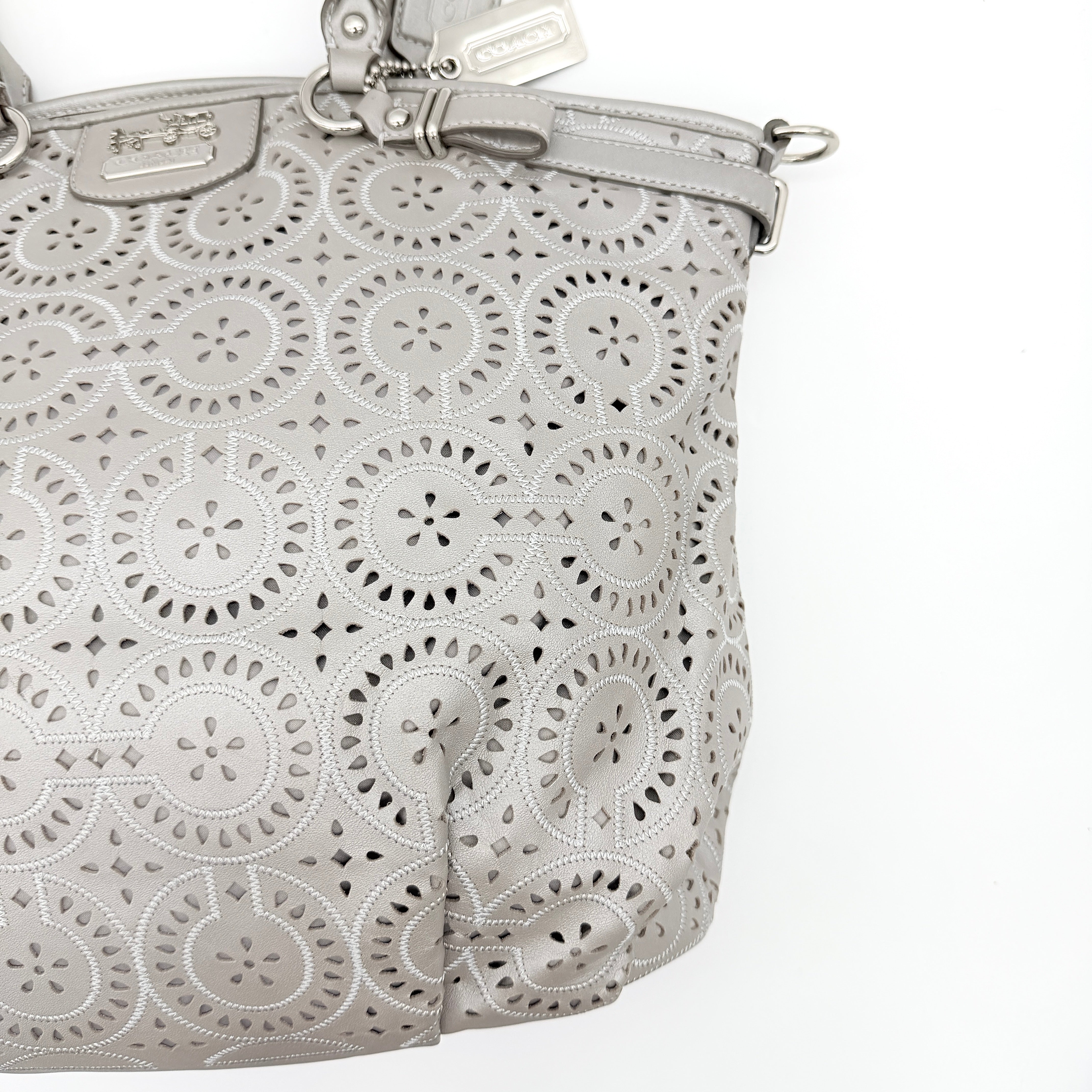 Coach Madison Sophia Shoulder Bag in silver leather with intricate cutout details, shown with original dust bag and detachable strap.