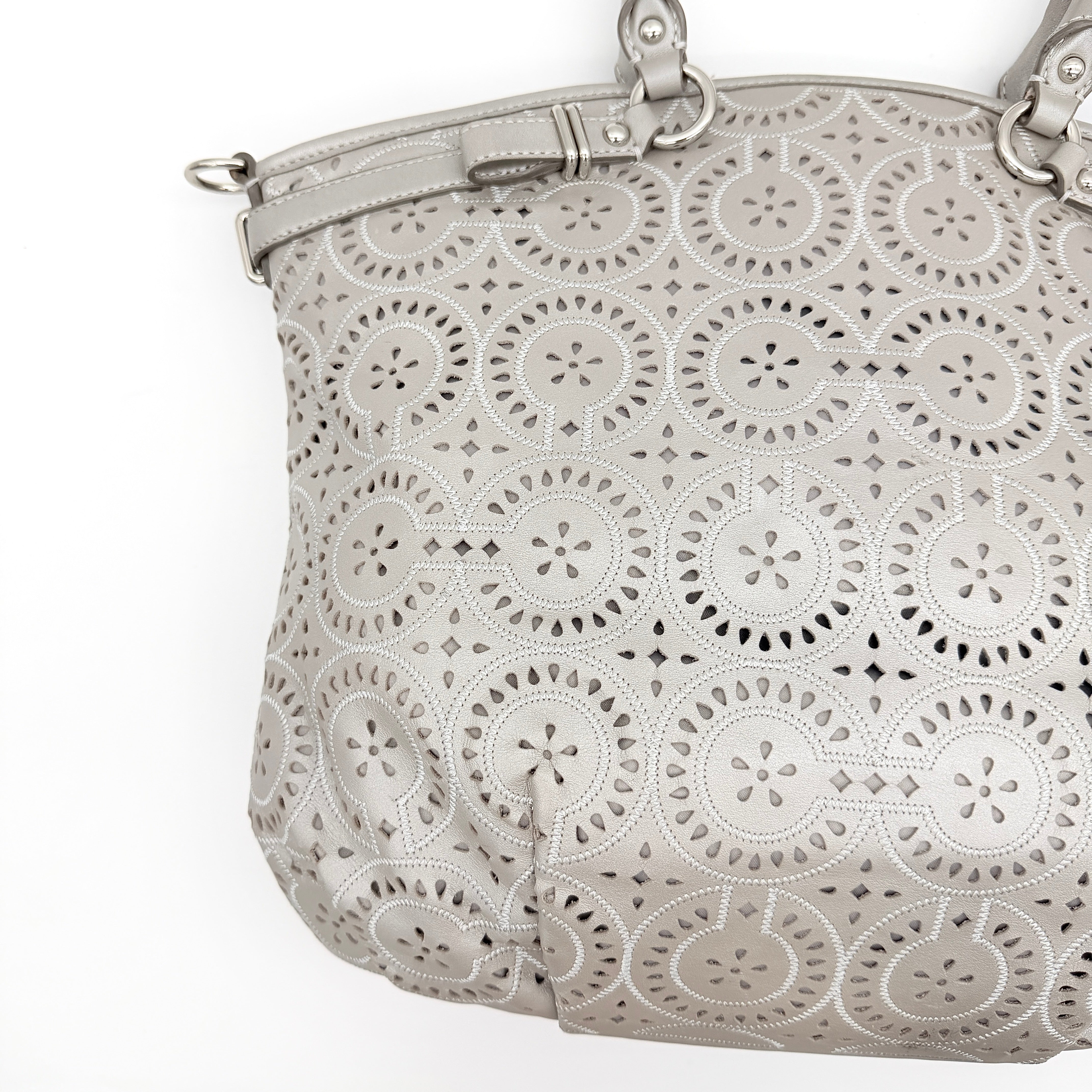Coach Madison Sophia Shoulder Bag in silver leather with intricate cutout details, shown with original dust bag and detachable strap.