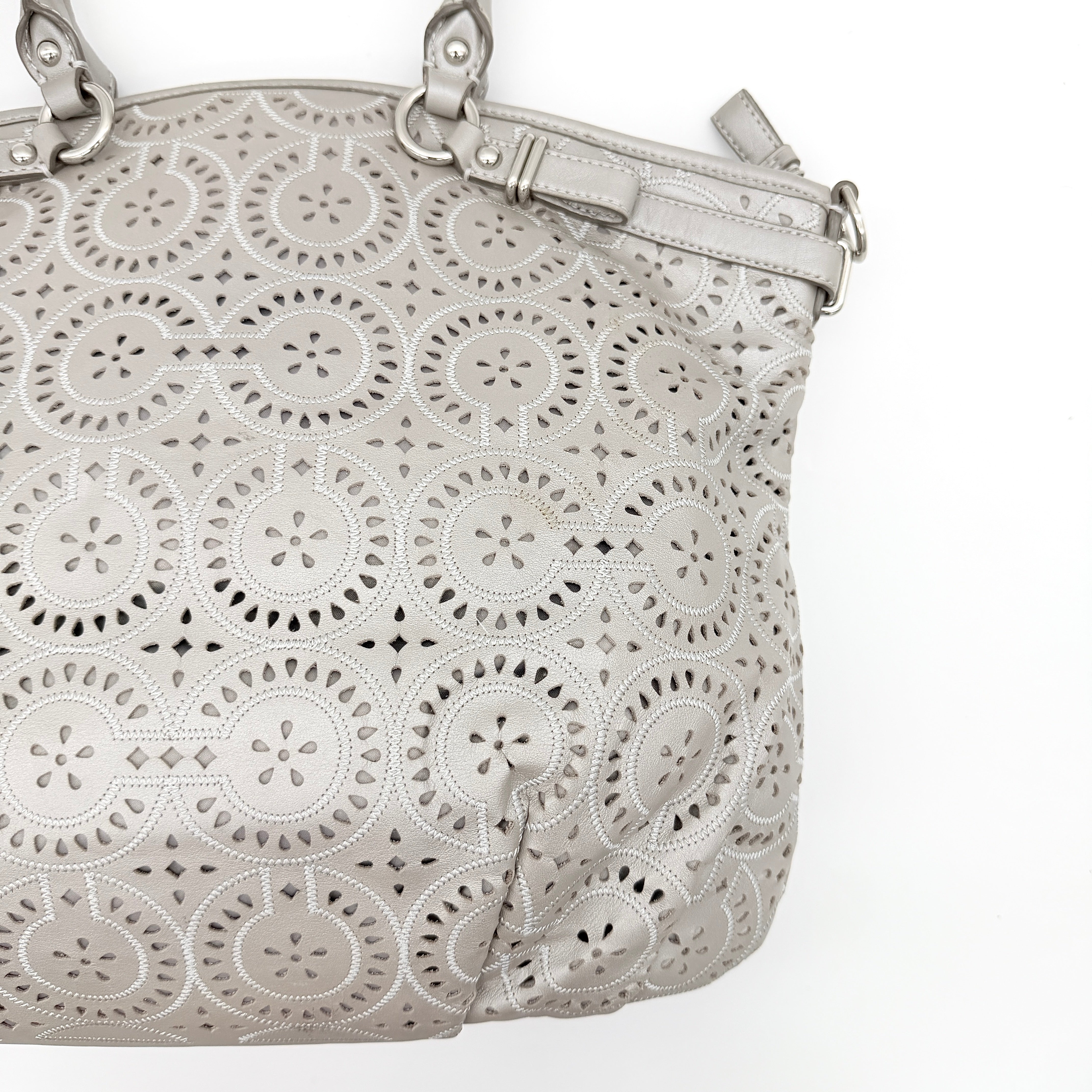 Coach Madison Sophia Shoulder Bag in silver leather with intricate cutout details, shown with original dust bag and detachable strap.