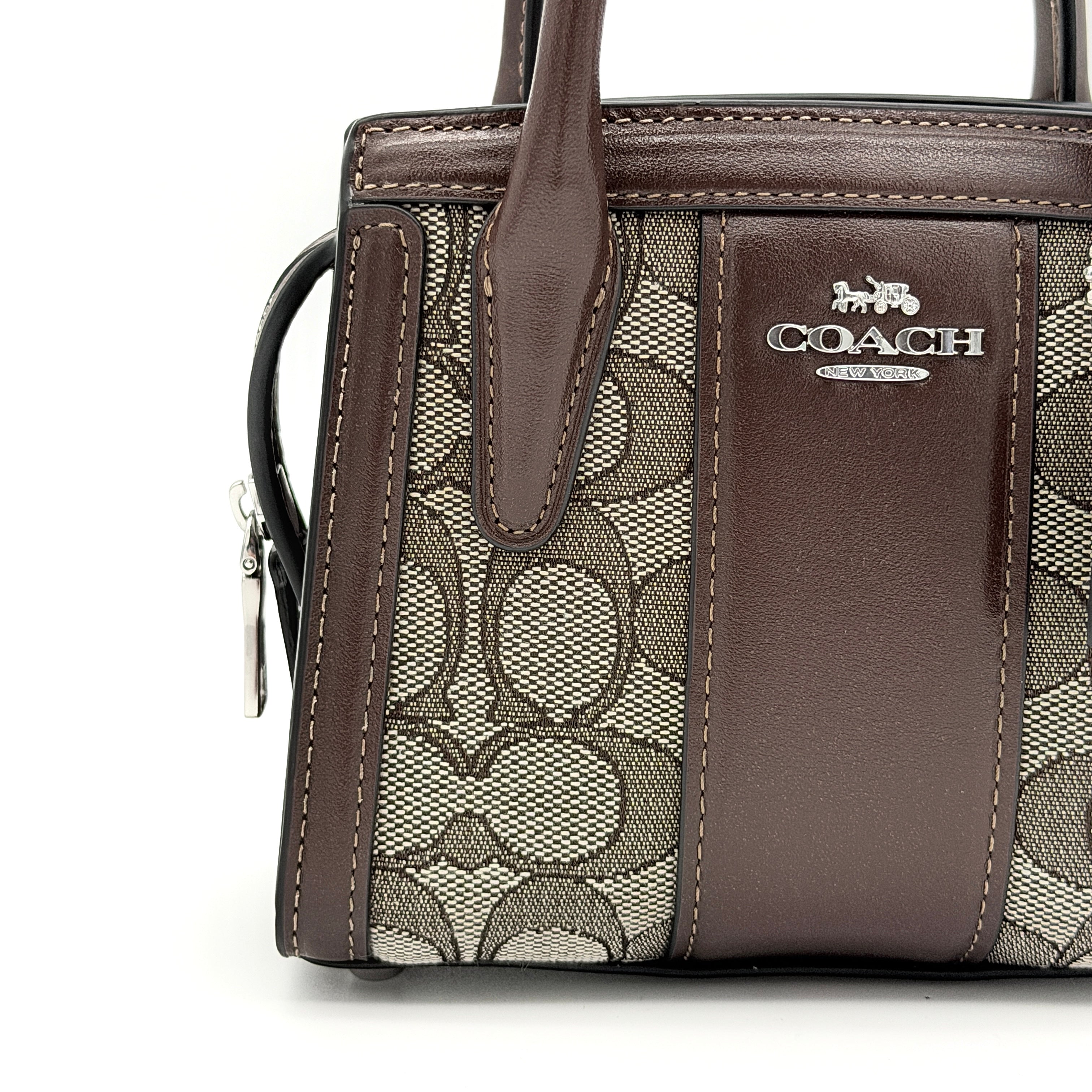 Front view of the Coach Signature Mini Andrea Carryall Shoulder Bag in brown canvas and leather with silver hardware.