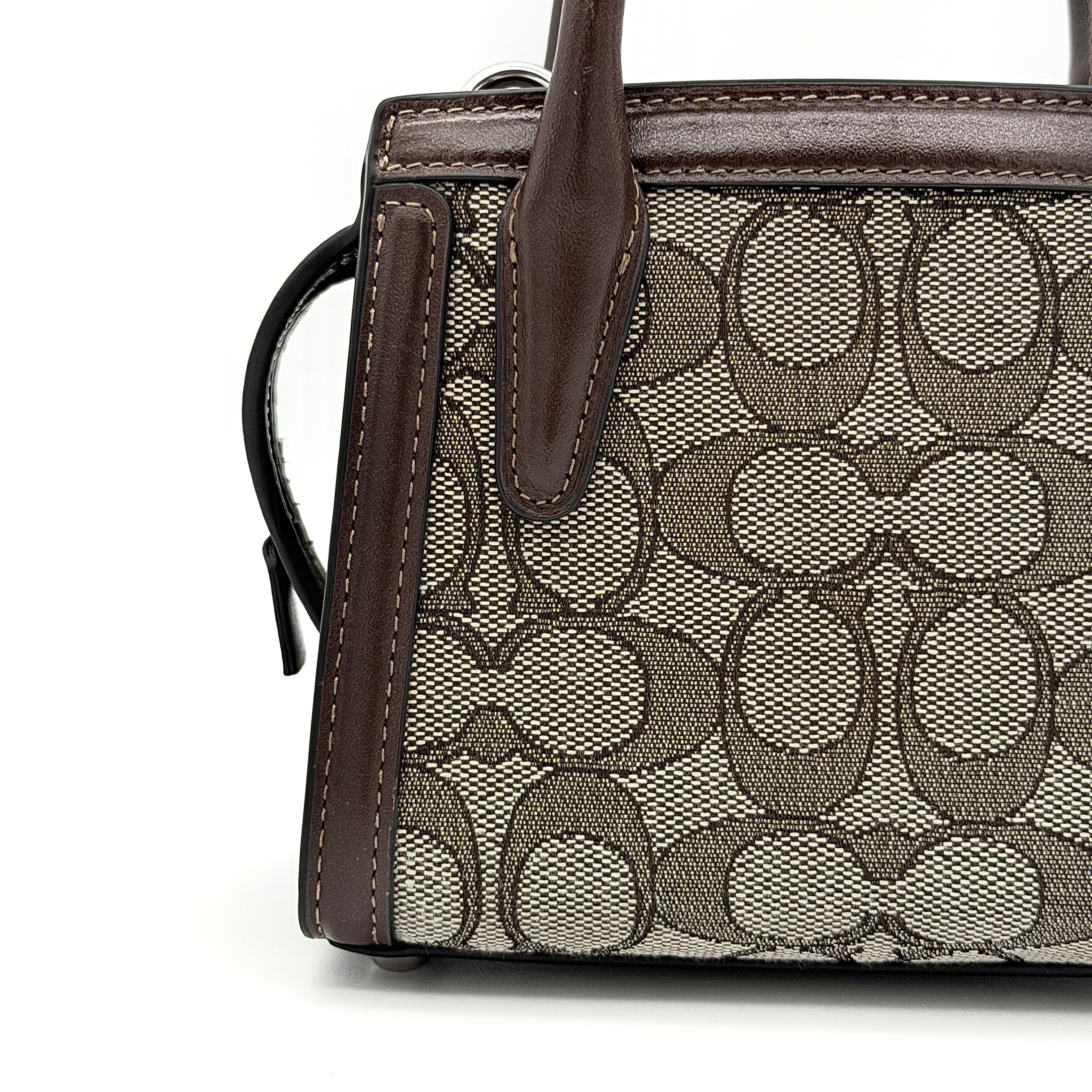 Front view of the Coach Signature Mini Andrea Carryall Shoulder Bag in brown canvas and leather with silver hardware.