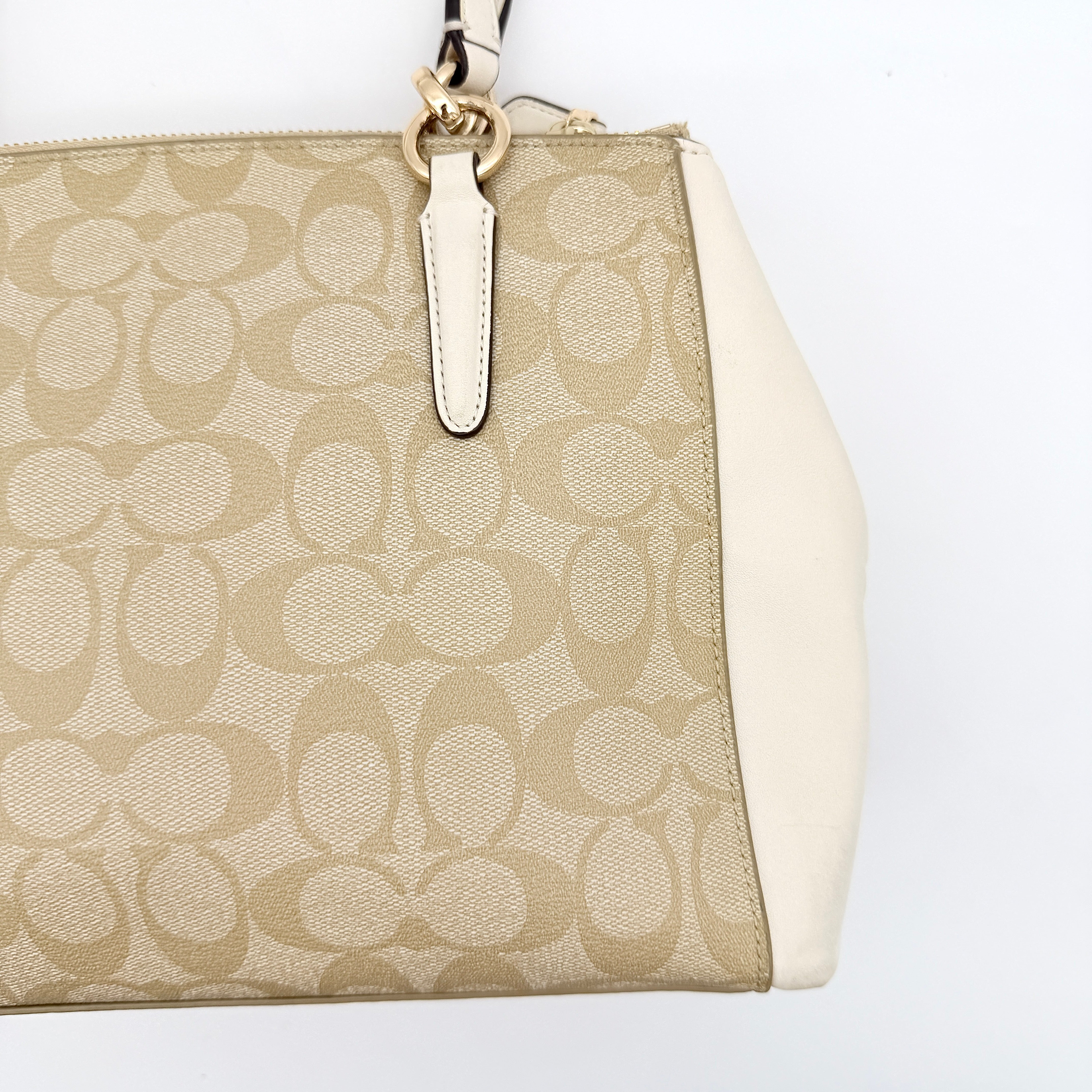 Coach Signature Christie Carryall in beige jacquard with white leather panels, double handles, and detachable strap.