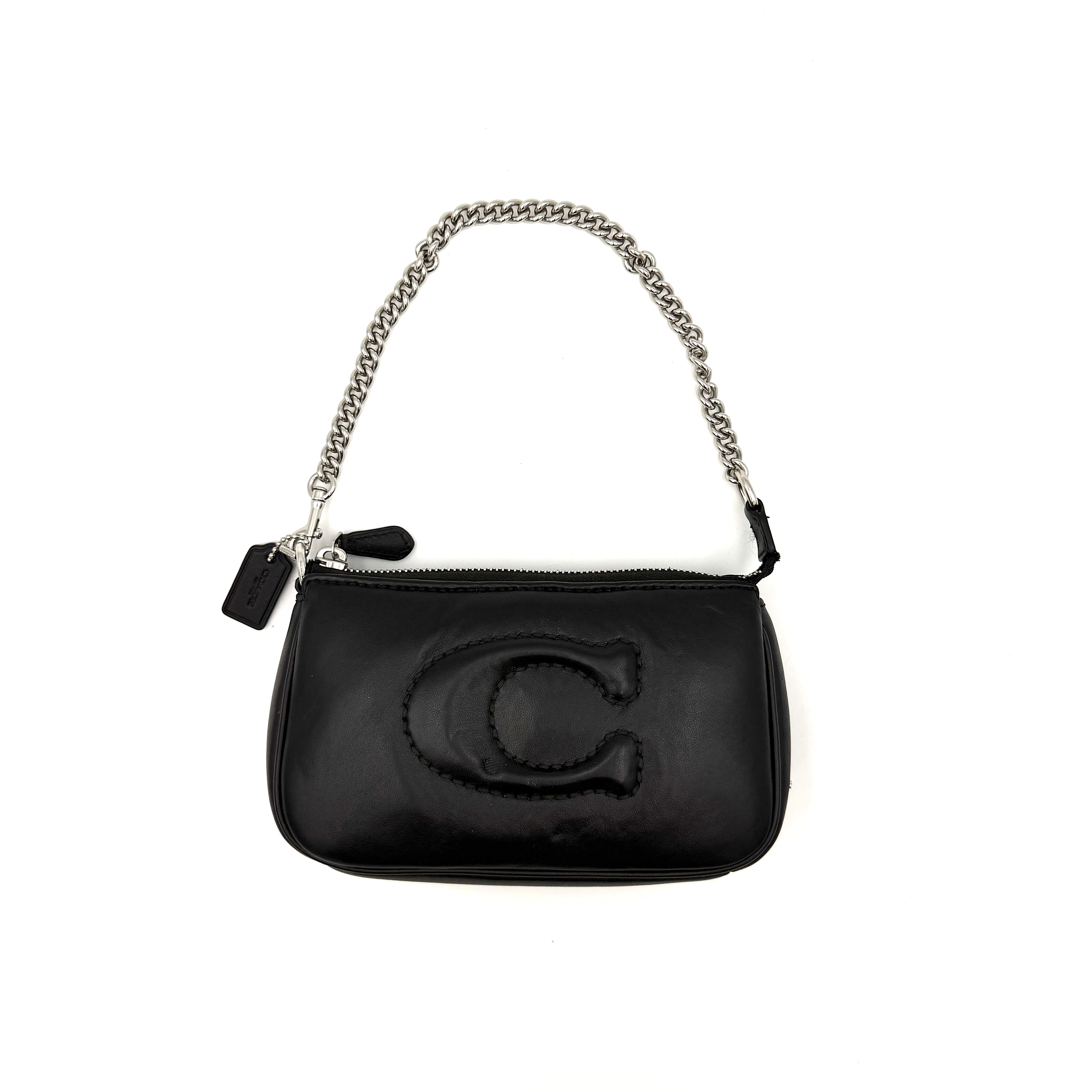 Coach Nolita 19 shoulder bag in quilted black leather with a bold stitched 'C' emblem and chunky silver chain strap.