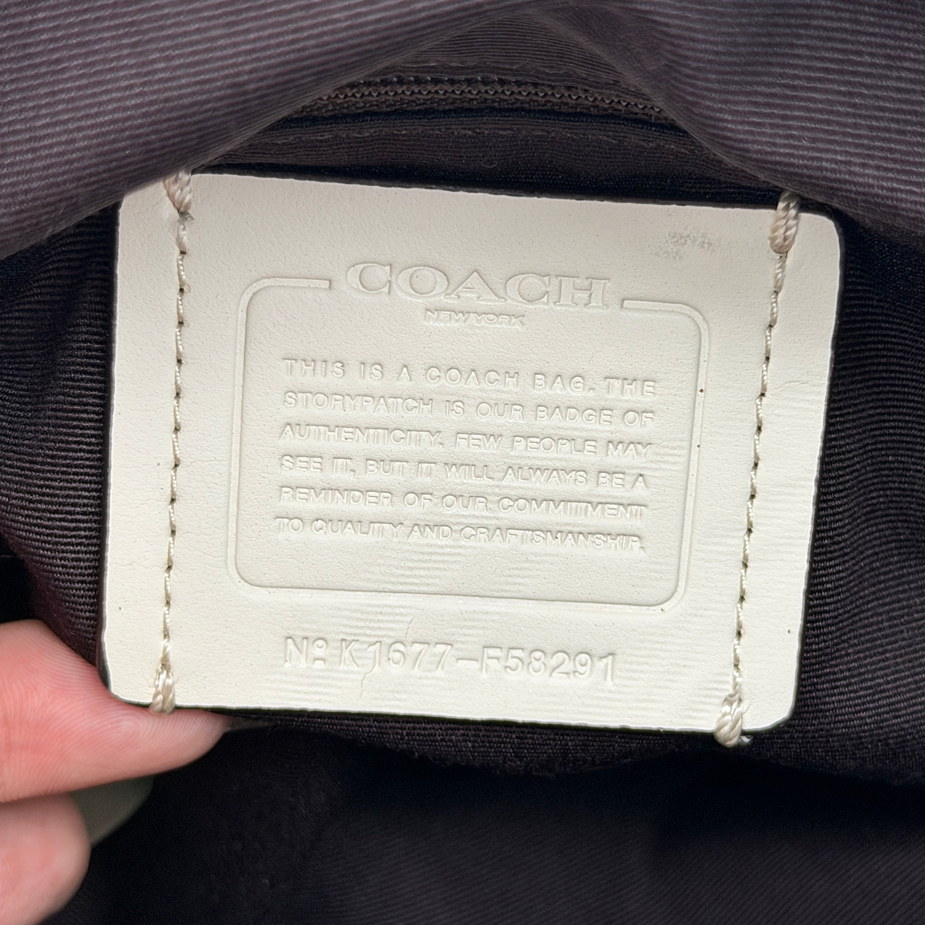 Coach Signature Christie Carryall in beige jacquard with white leather panels, double handles, and detachable strap.