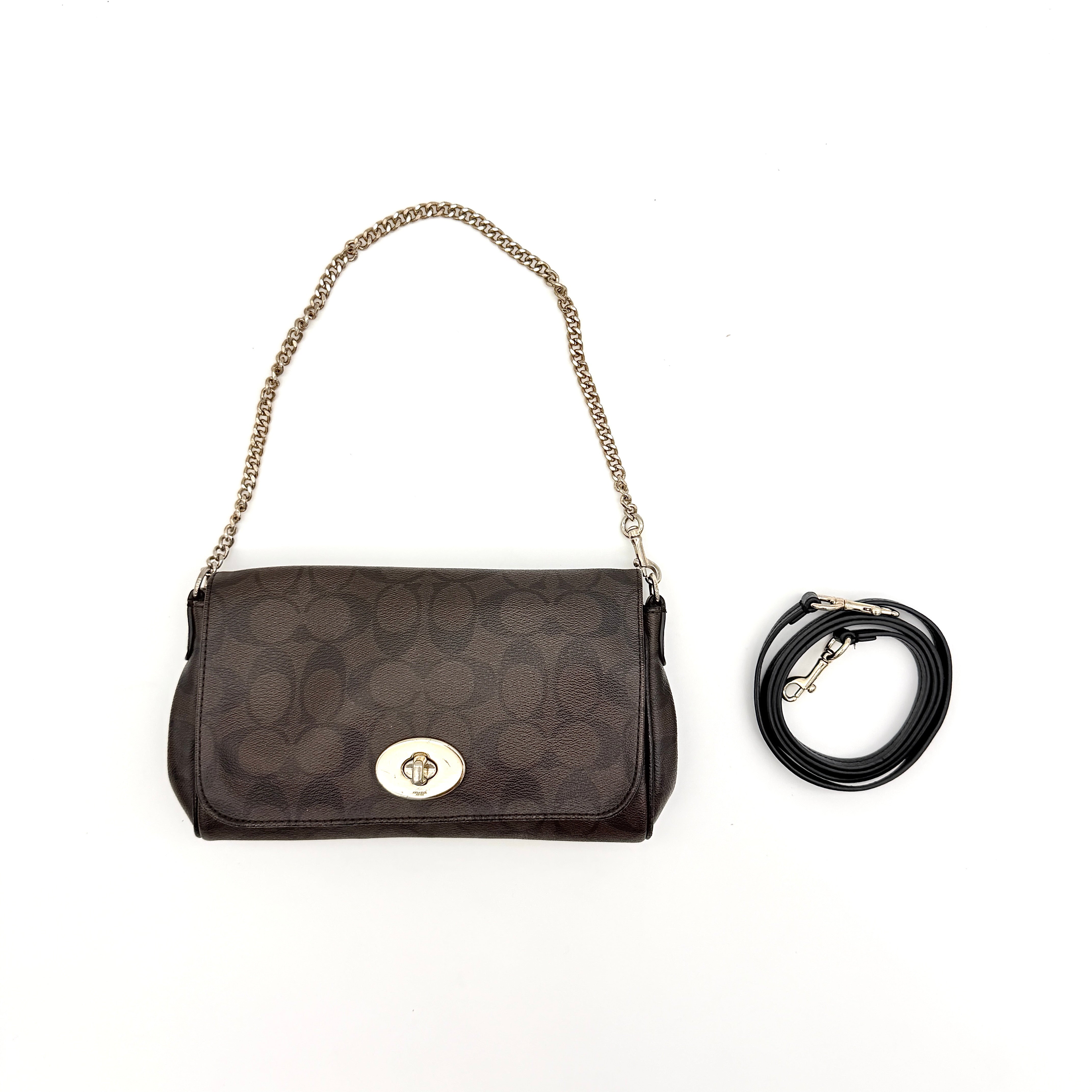 Coach Signature Ruby shoulder bag in brown and black with gold chain strap and detachable leather crossbody strap, displayed on a white background.