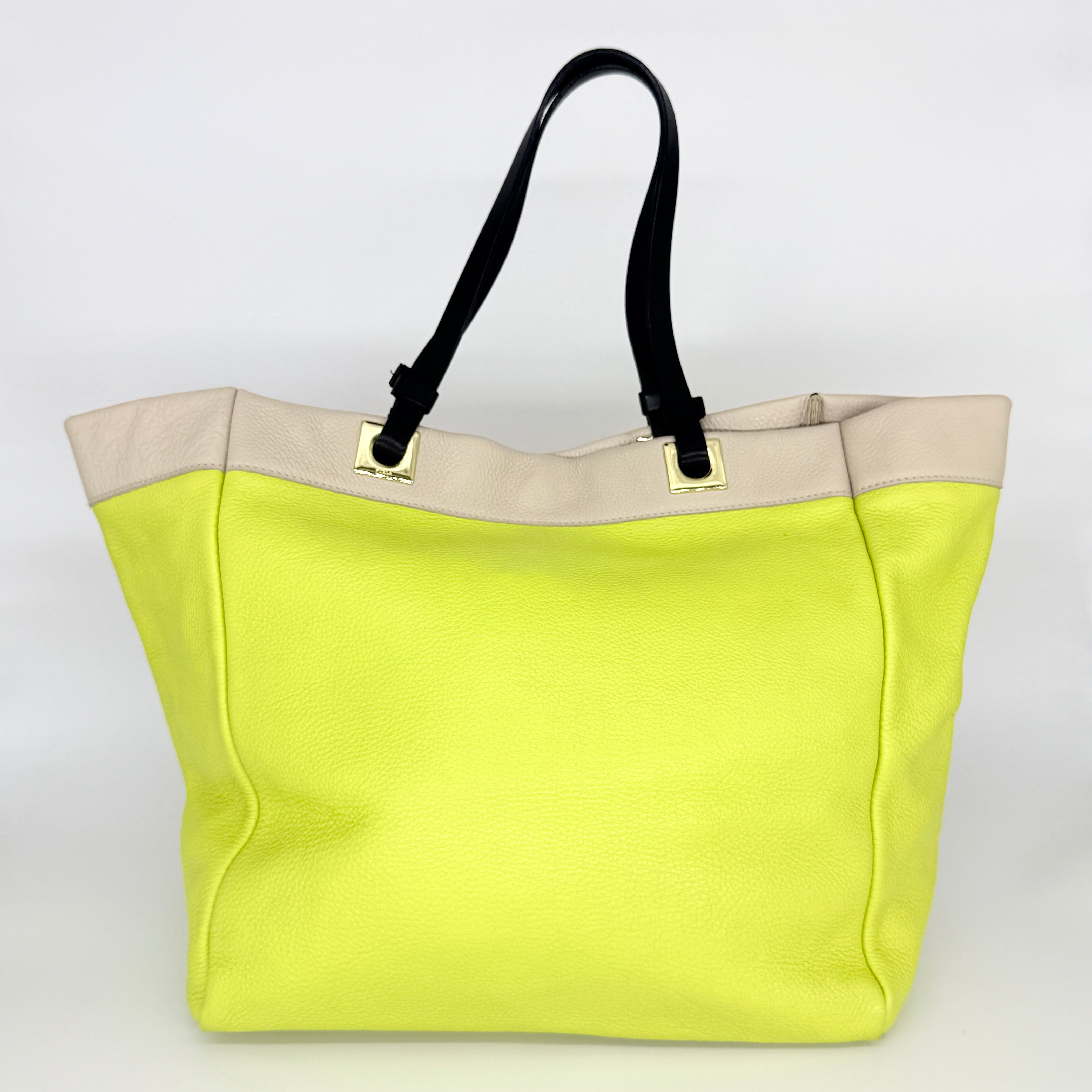 Furla Shopper Tote in neon yellow and beige grained leather with black handles and gold-tone hardware.