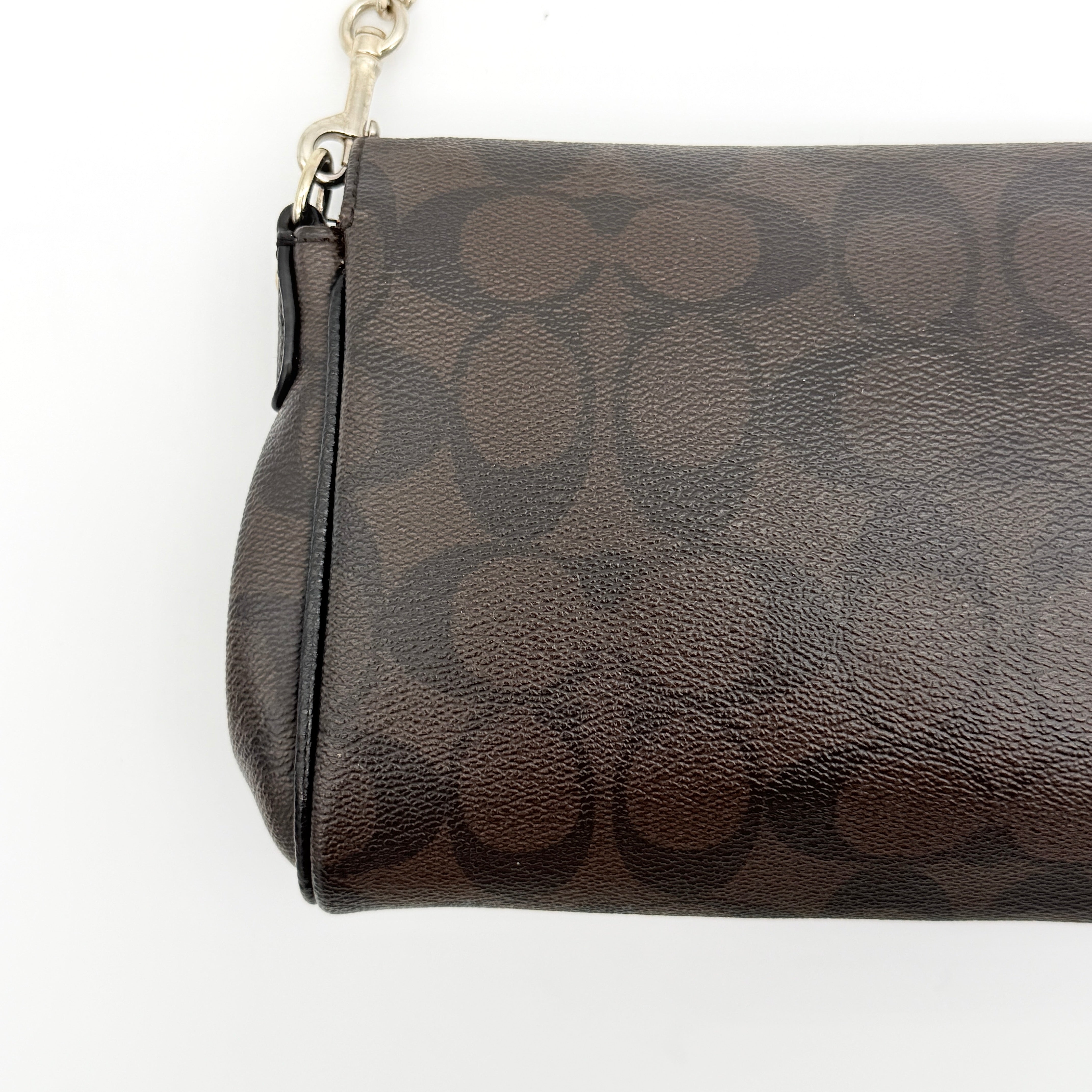 Coach Signature Ruby shoulder bag in brown and black with gold chain strap and detachable leather crossbody strap, displayed on a white background.