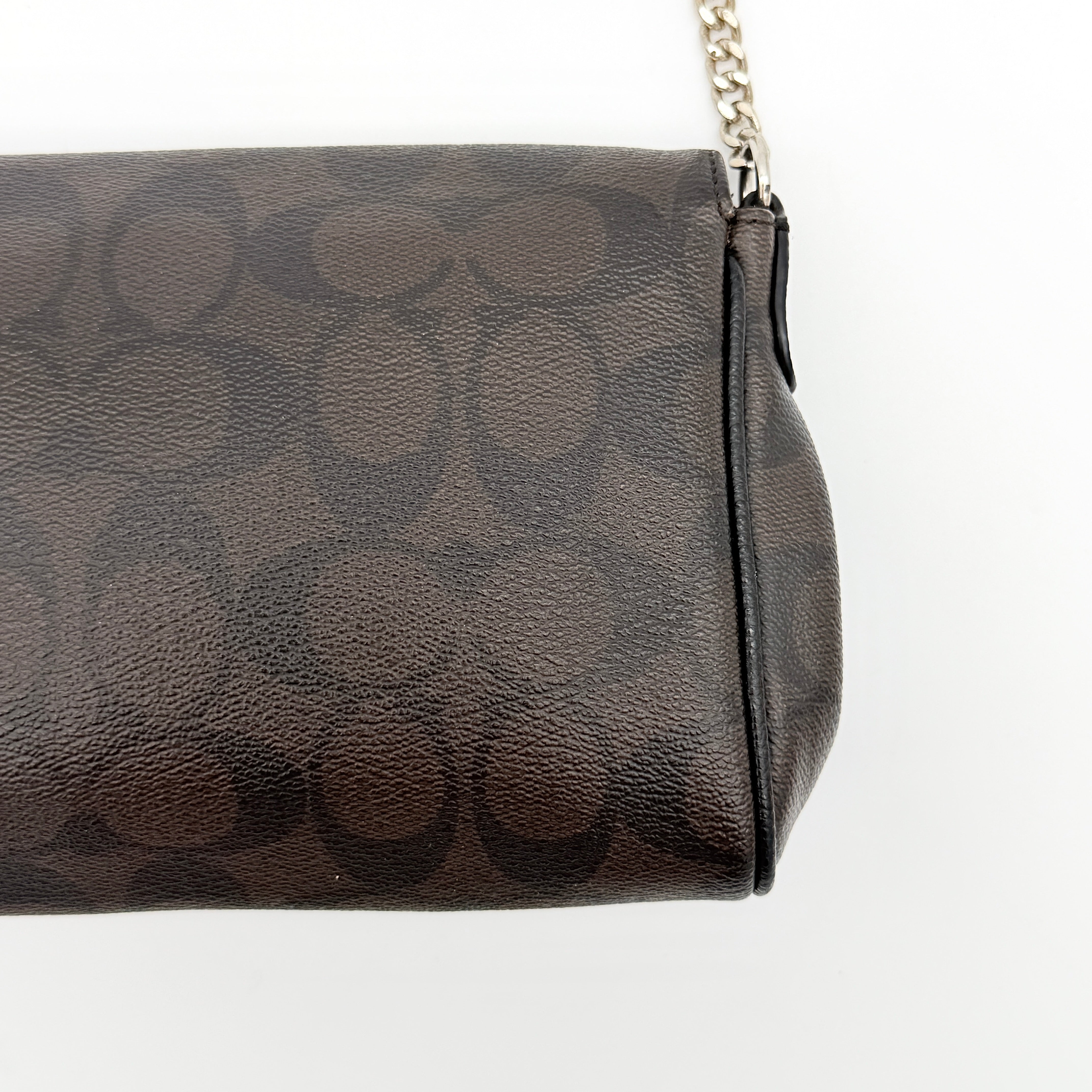 Coach Signature Ruby shoulder bag in brown and black with gold chain strap and detachable leather crossbody strap, displayed on a white background.