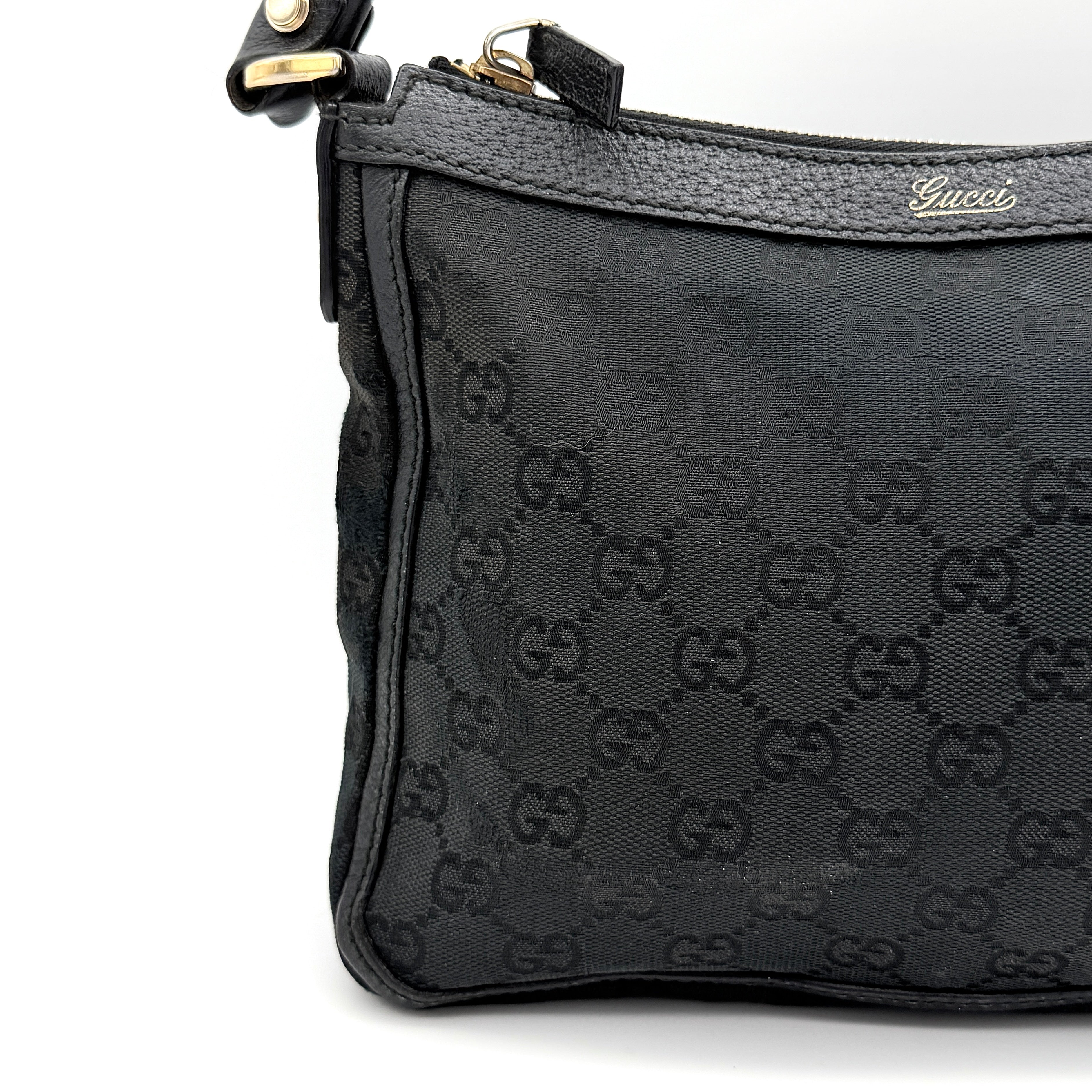 Front view of the Gucci GG Monogram Abbey Shoulder Bag in black with curved handle and gold hardware.