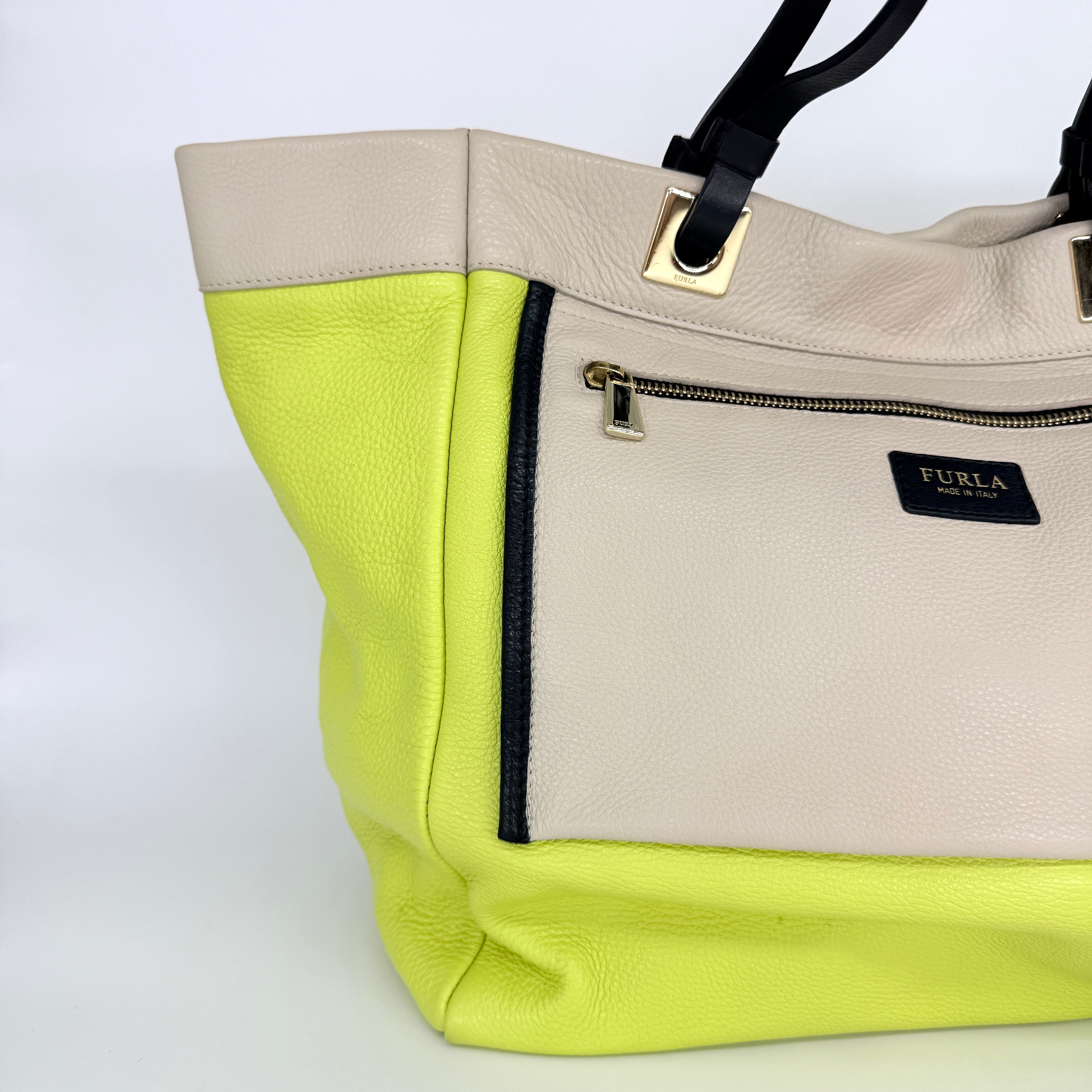 Furla Shopper Tote in neon yellow and beige grained leather with black handles and gold-tone hardware.