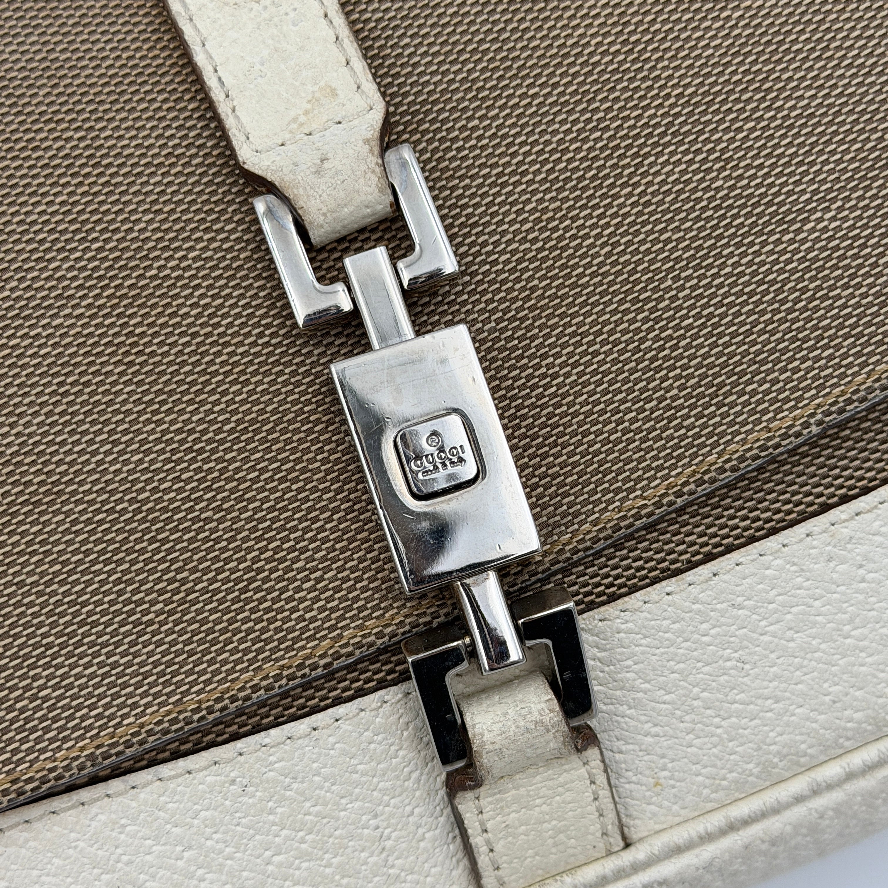 Gucci Jackie Shoulder Bag in brown canvas and white leather trim with silver-tone hardware, displayed against a clean background.