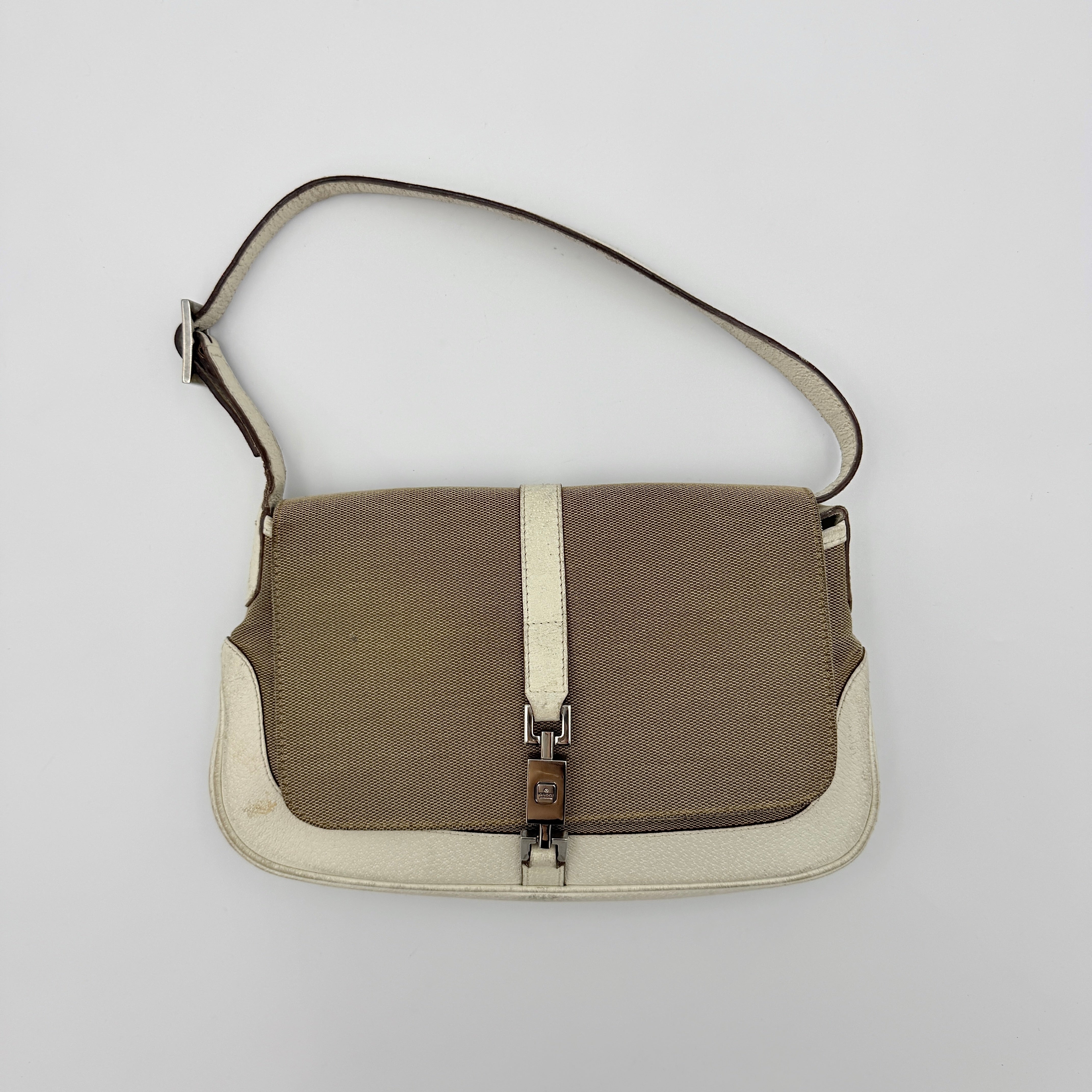 Gucci Jackie Shoulder Bag in brown canvas and white leather trim with silver-tone hardware, displayed against a clean background.