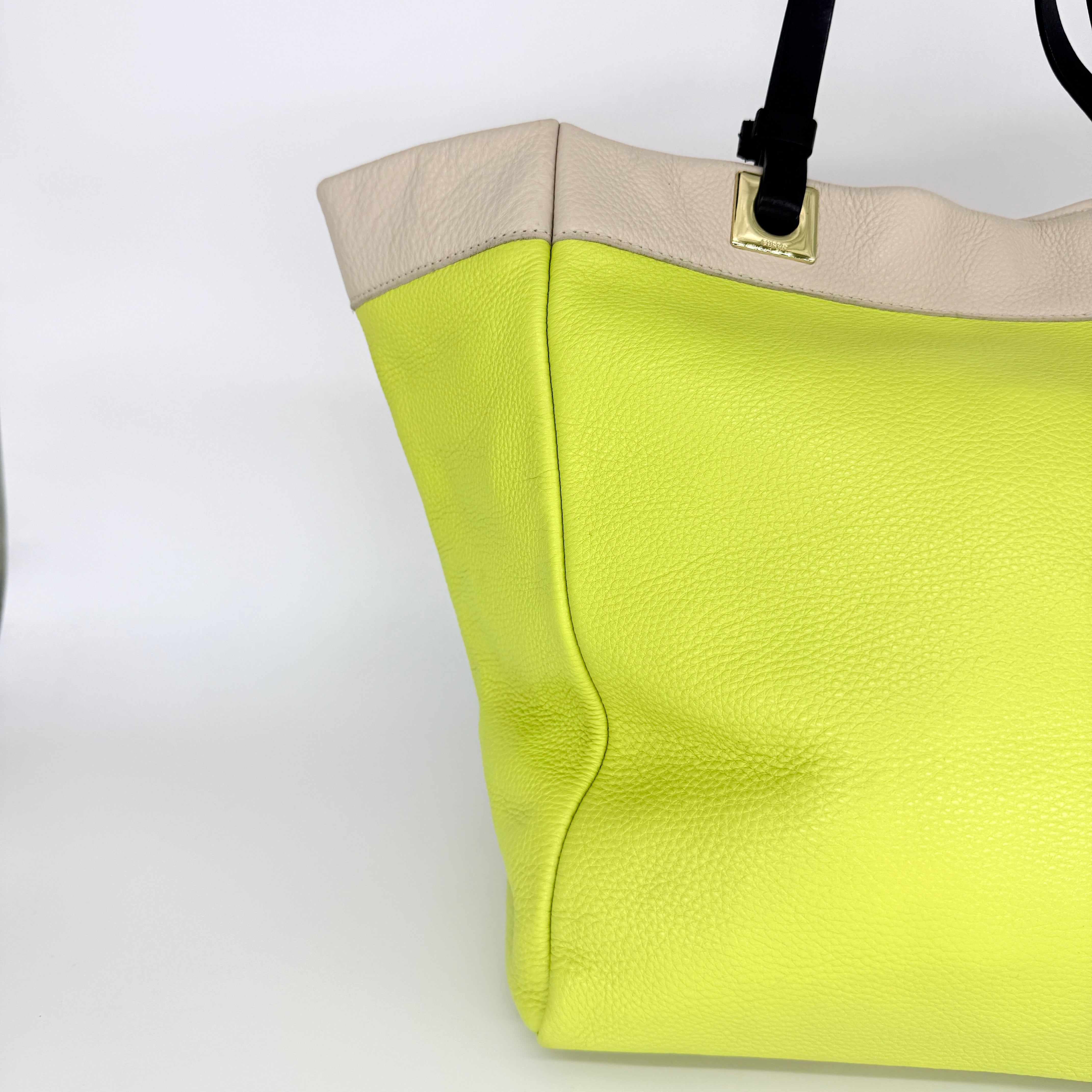 Furla Shopper Tote in neon yellow and beige grained leather with black handles and gold-tone hardware.